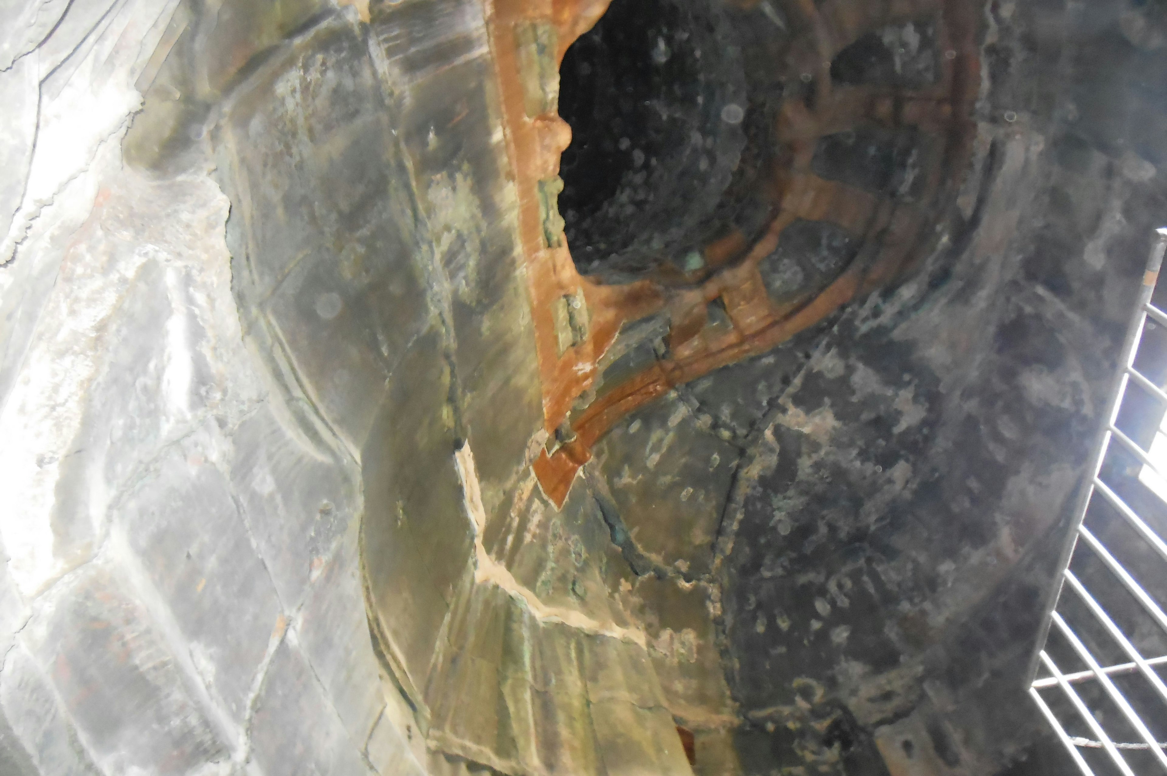 Image of an industrial interior showing rusted metal structures and curves