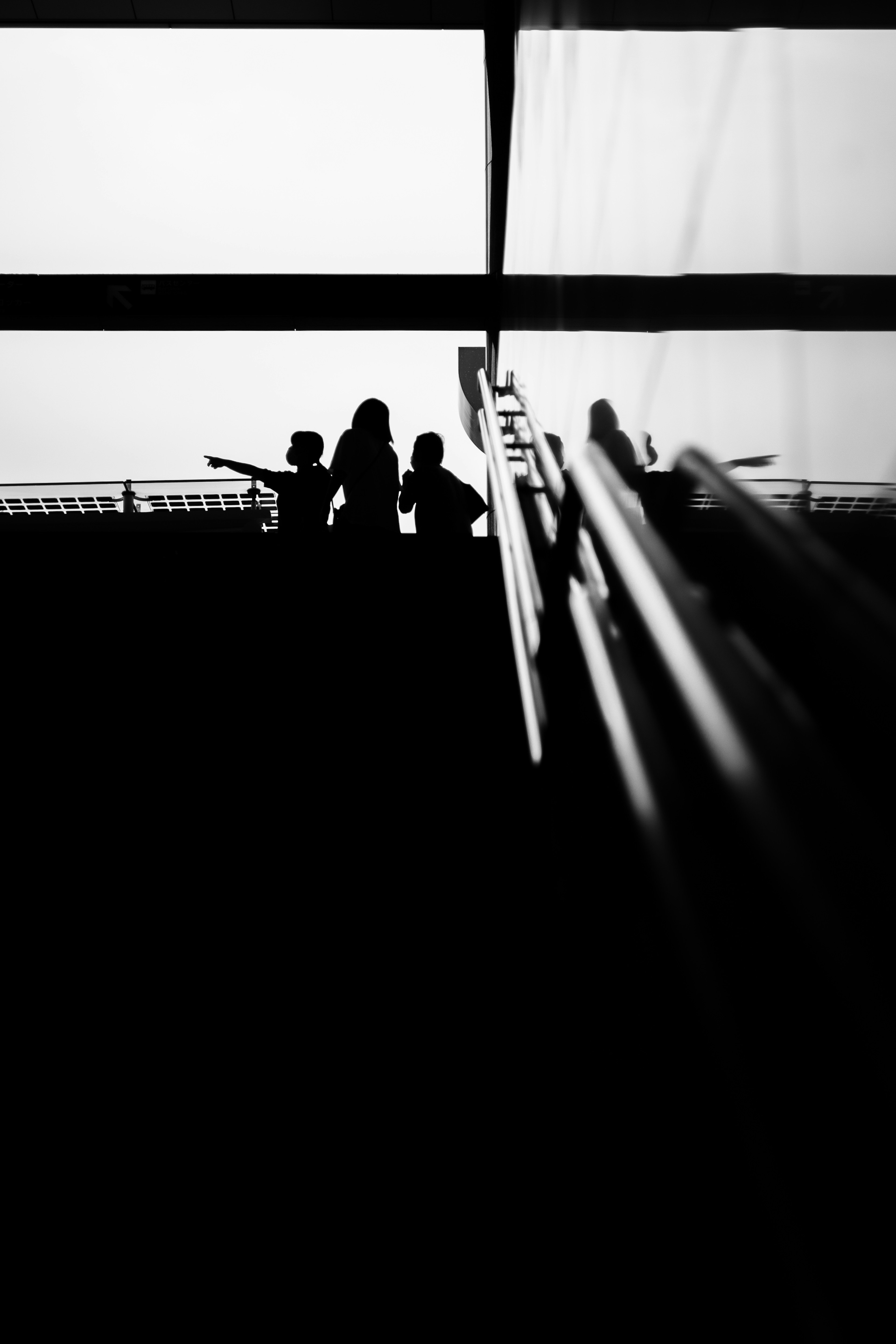 Silhouetted figures ascending stairs in black and white