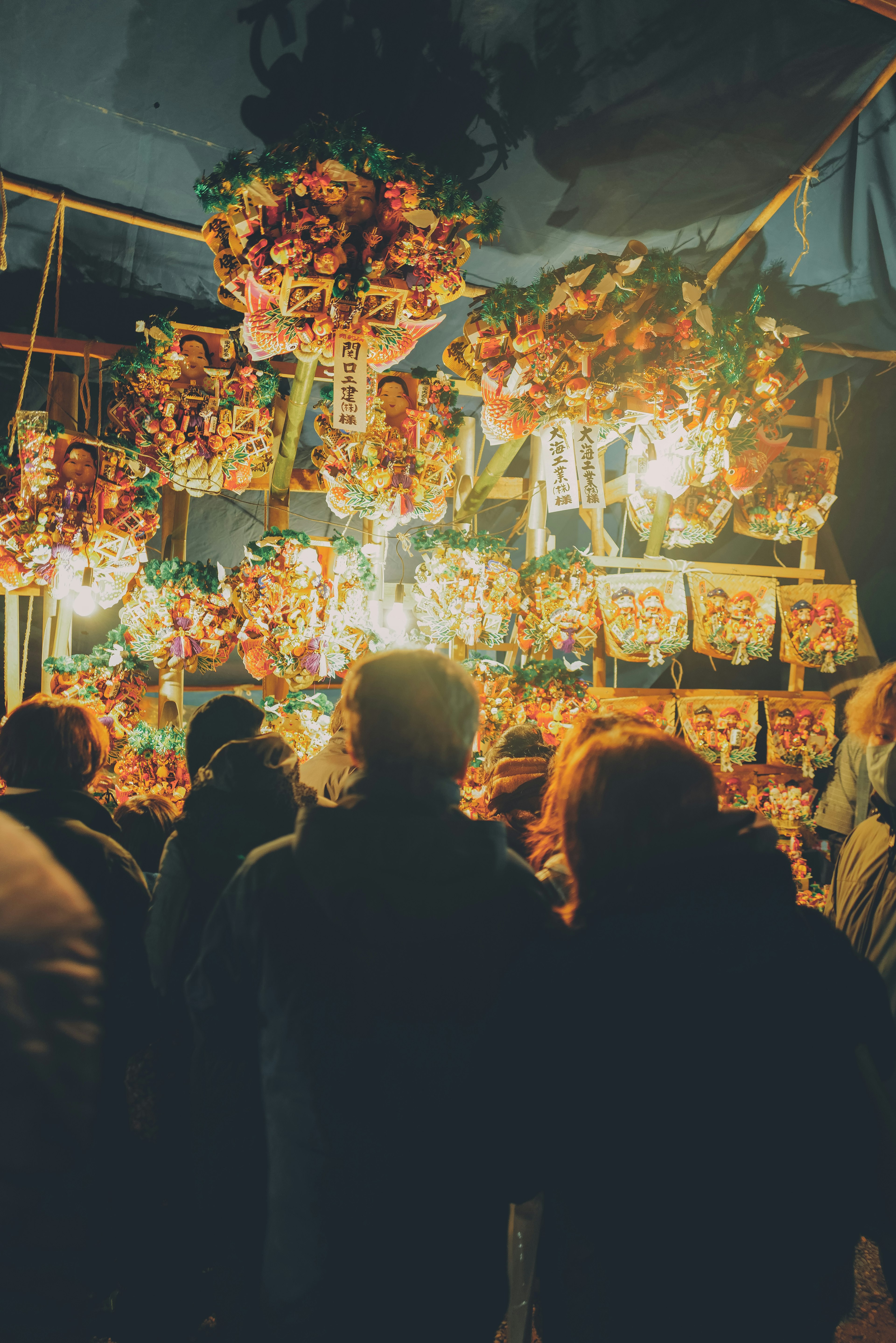 Crowd at a night market surrounded by vibrant decorations