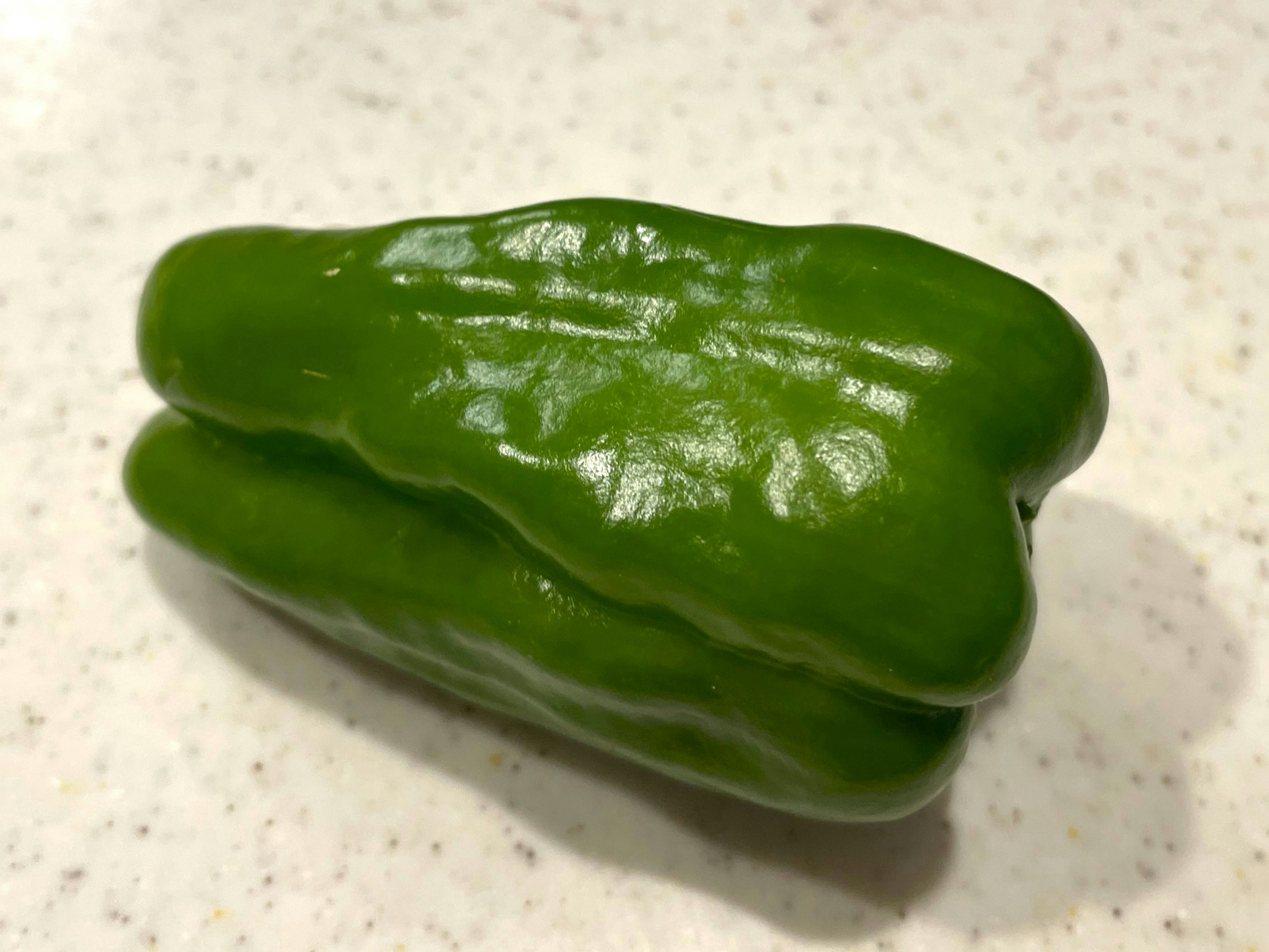 A green vegetable resembling a bell pepper