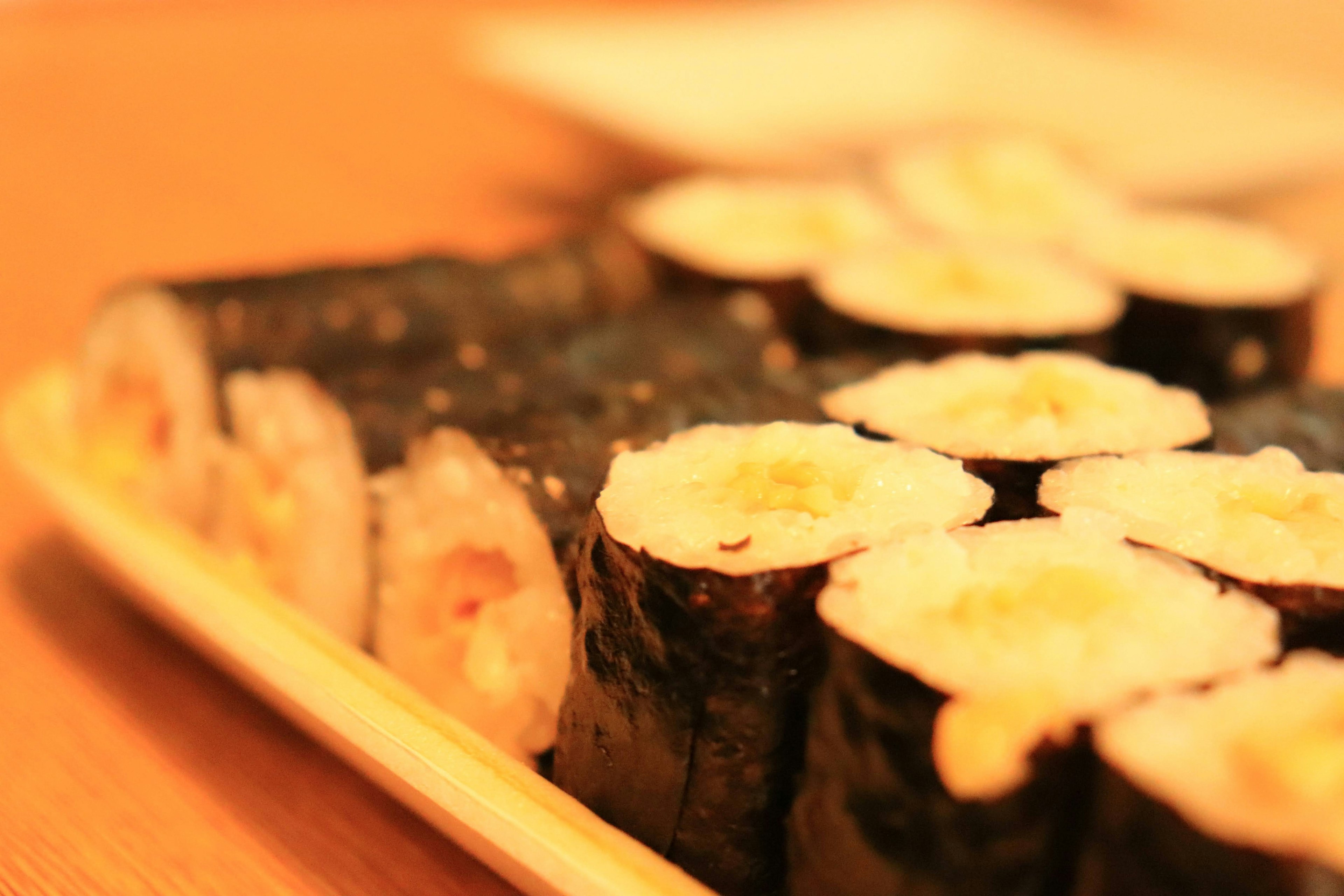 A delicious assortment of sushi arranged on a wooden plate