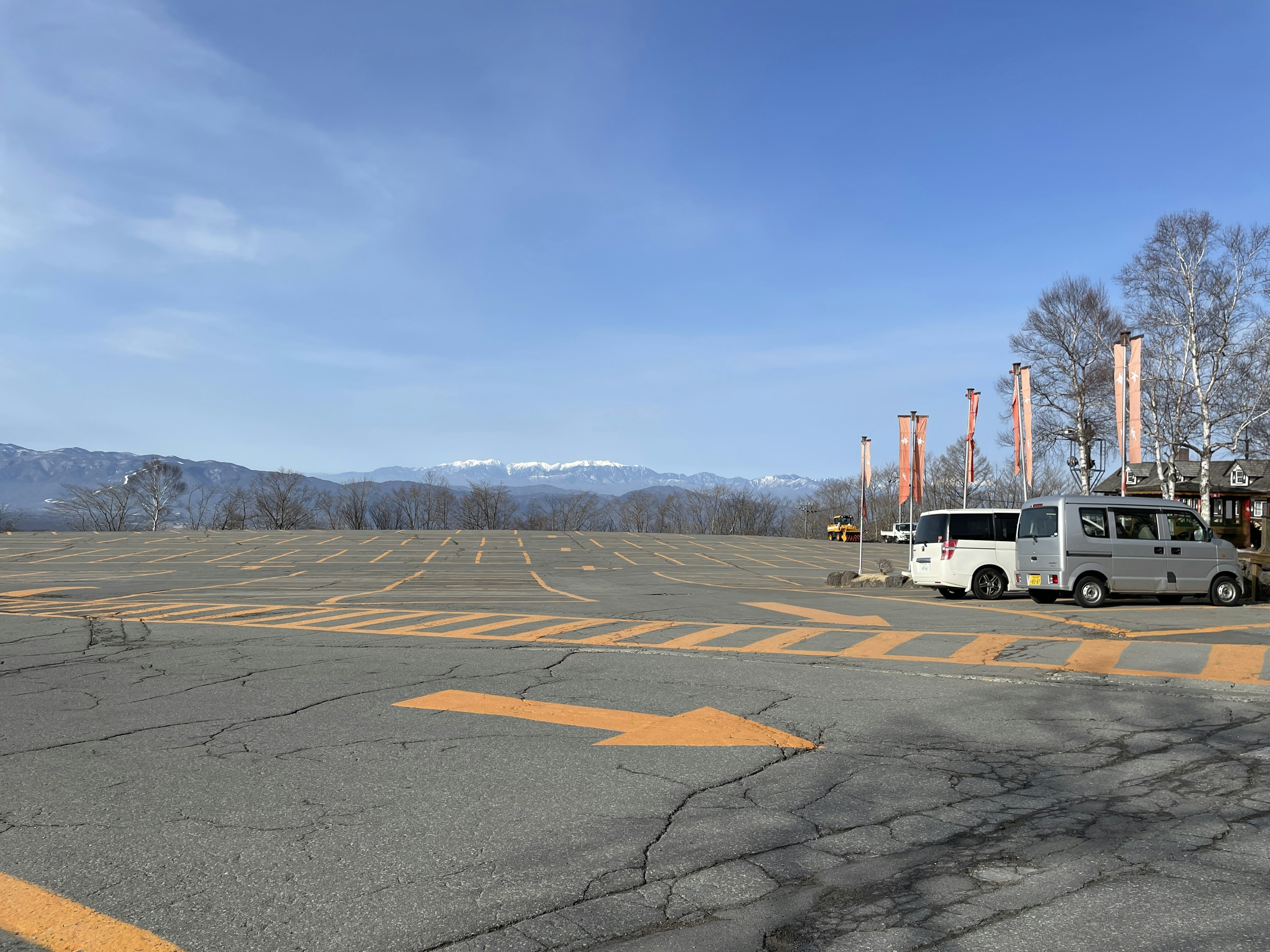 Wide parking lot with a bus under a blue sky