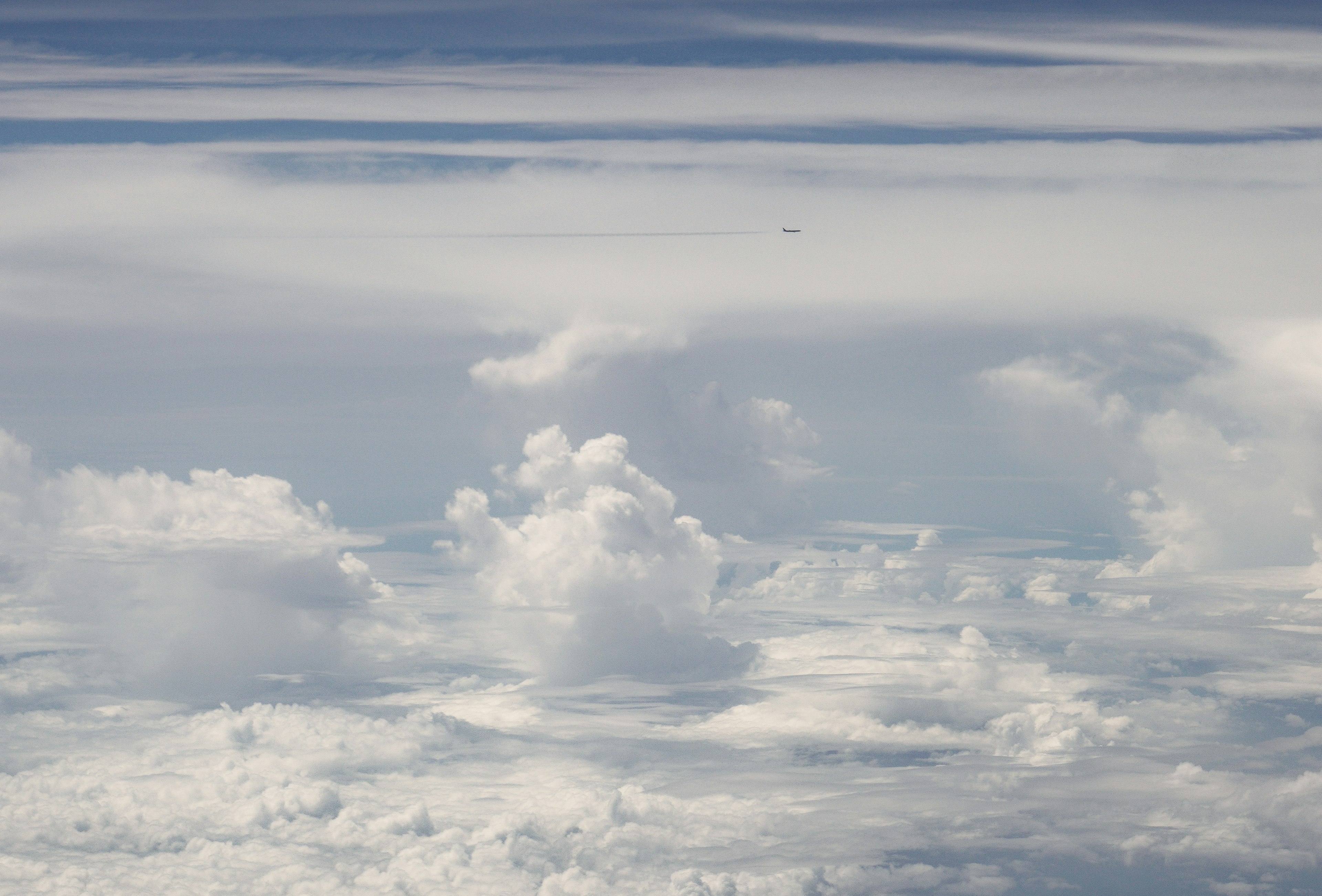 A landscape of white clouds floating in a blue sky