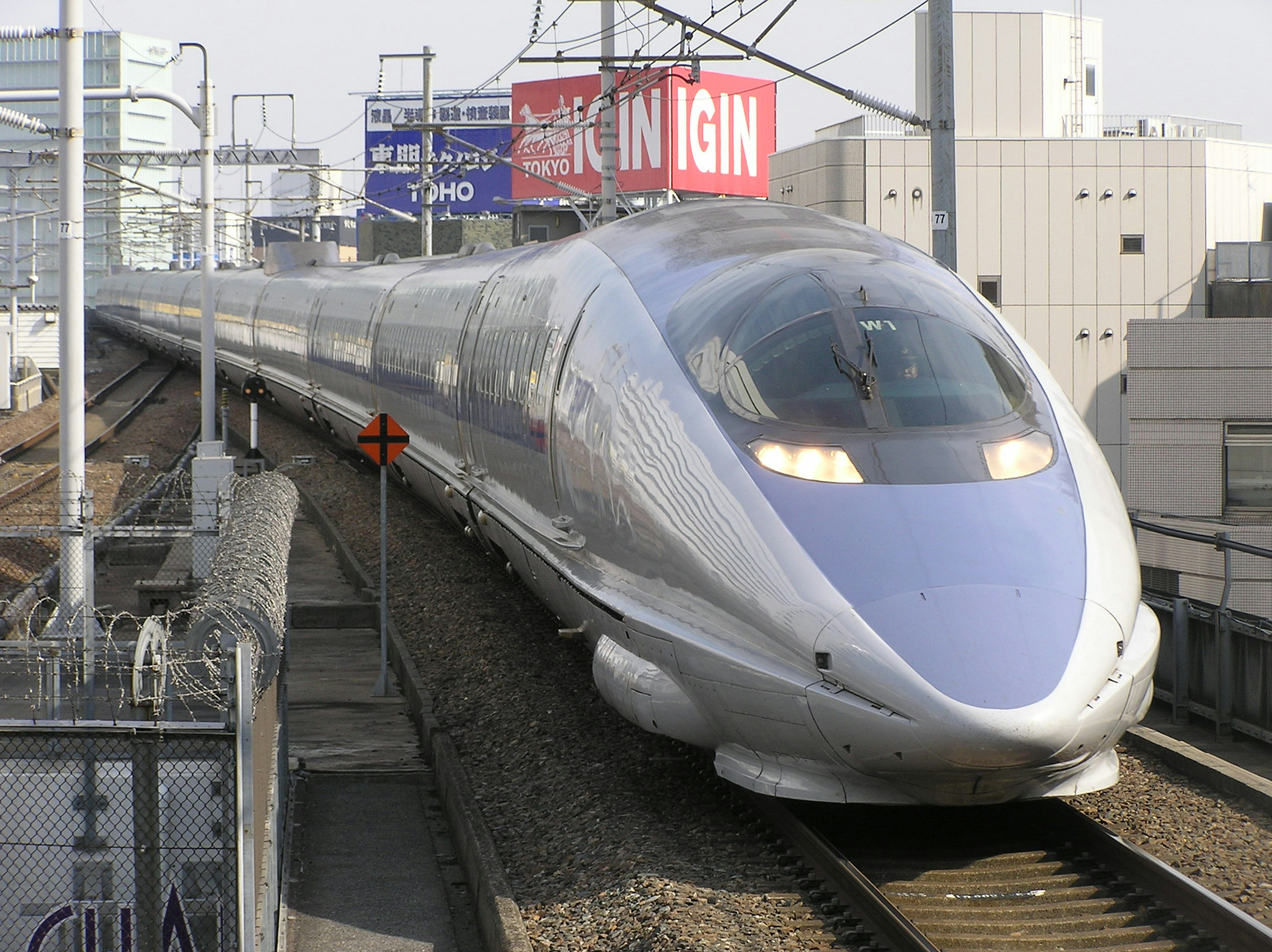 Shinkansen bullet train approaching on the tracks