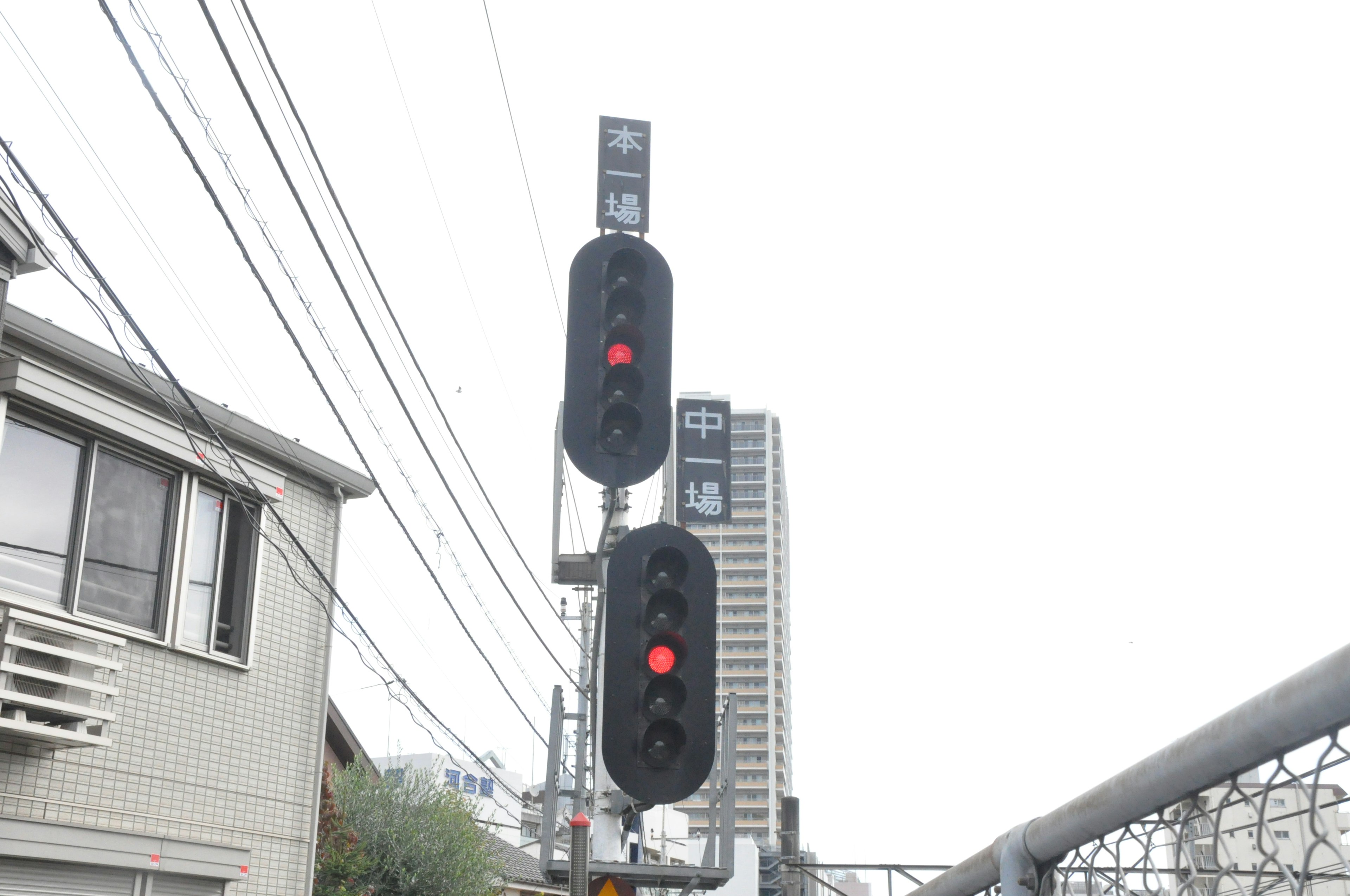 Traffic signal with red lights and surrounding buildings