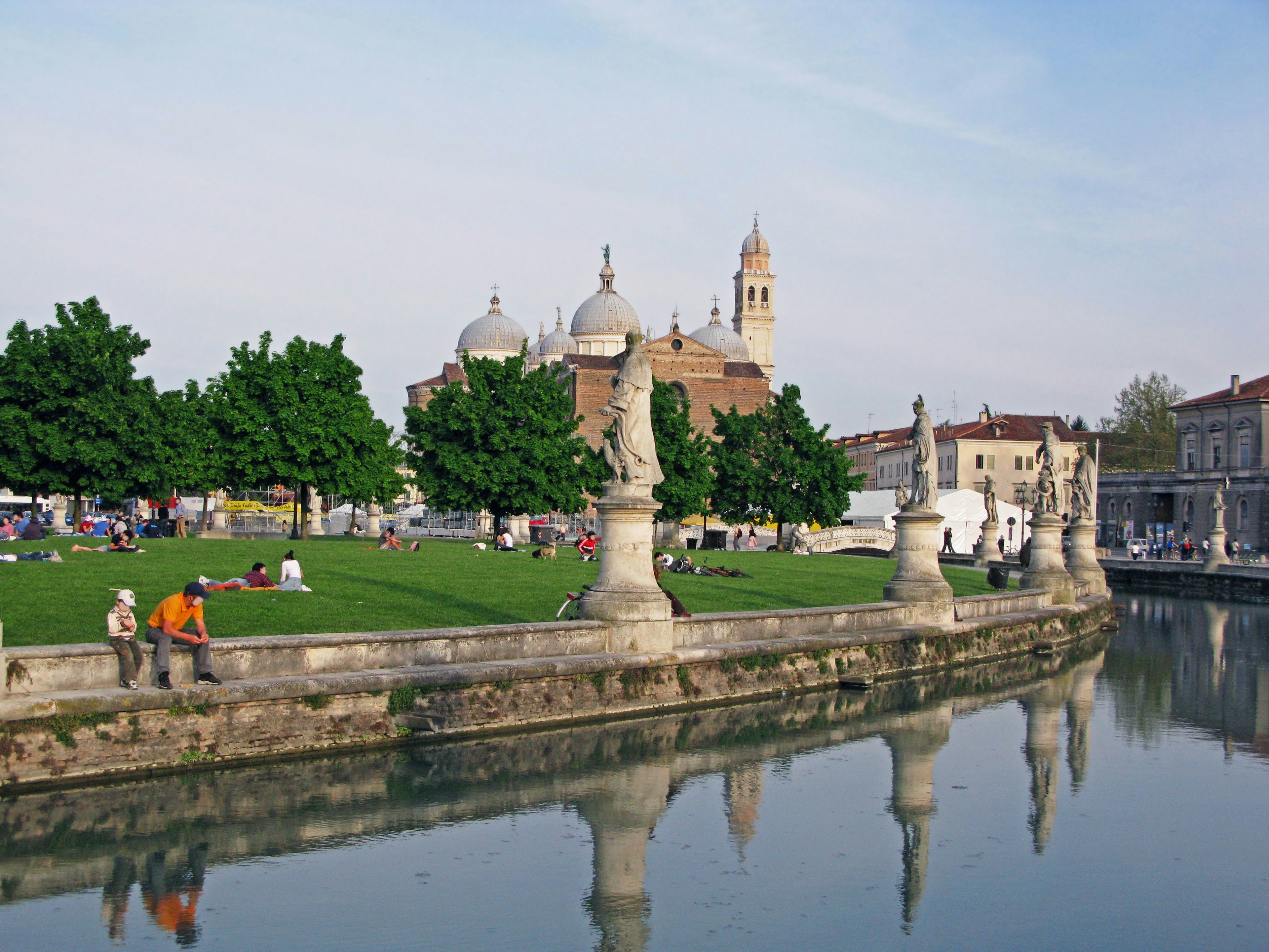 Scenic view of a park by a river with domed church in the background