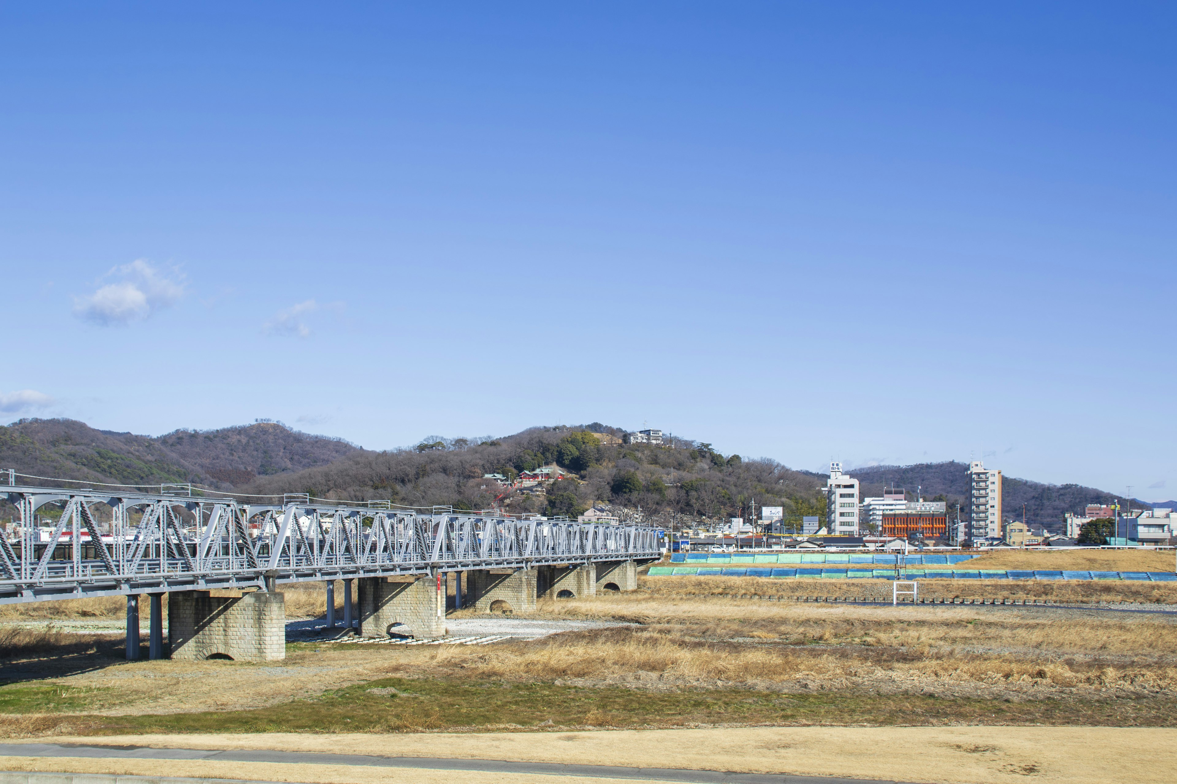 Landscape of a river and bridge under a blue sky