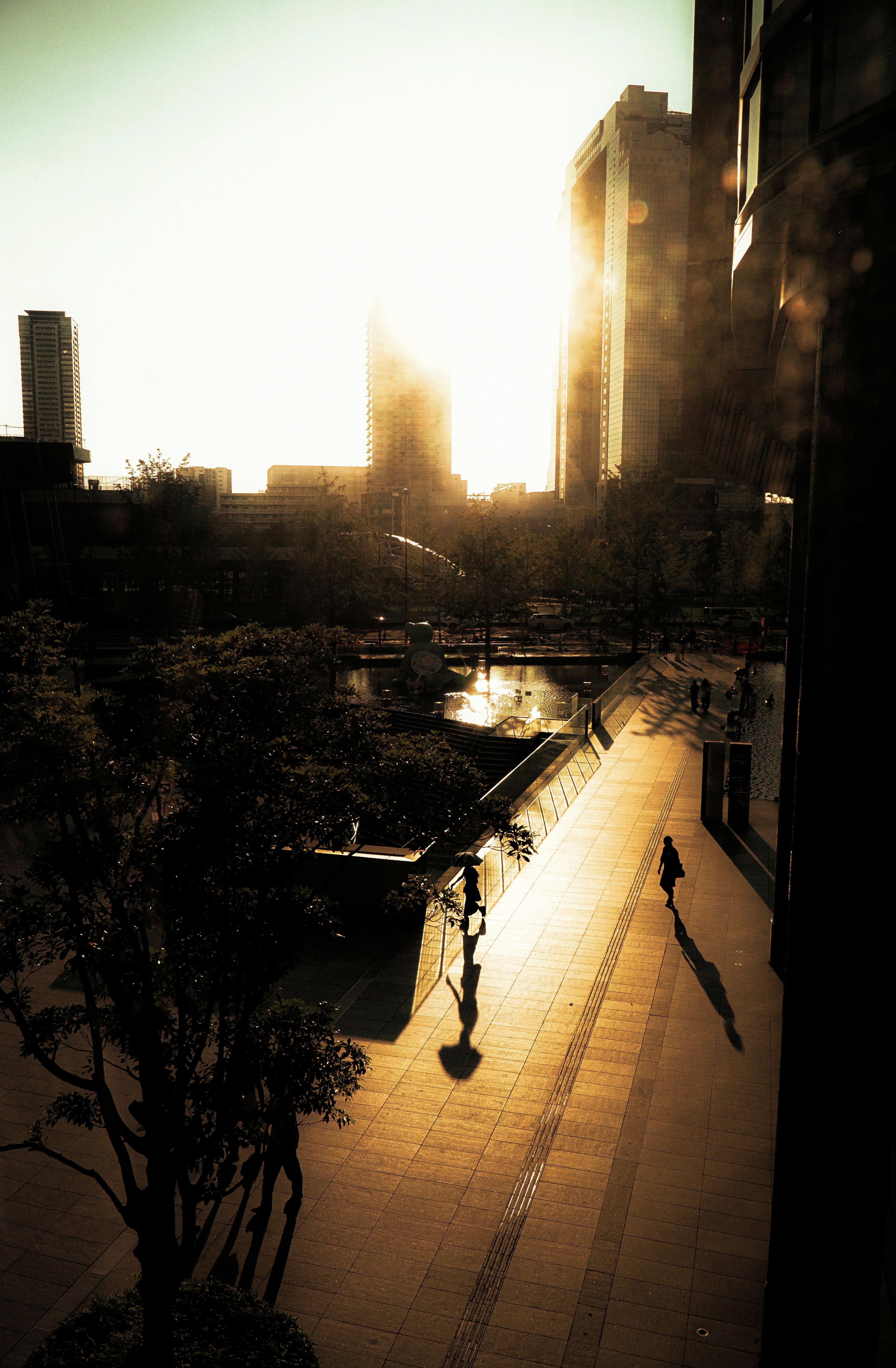 Urban landscape at sunset with shadows and reflections on water