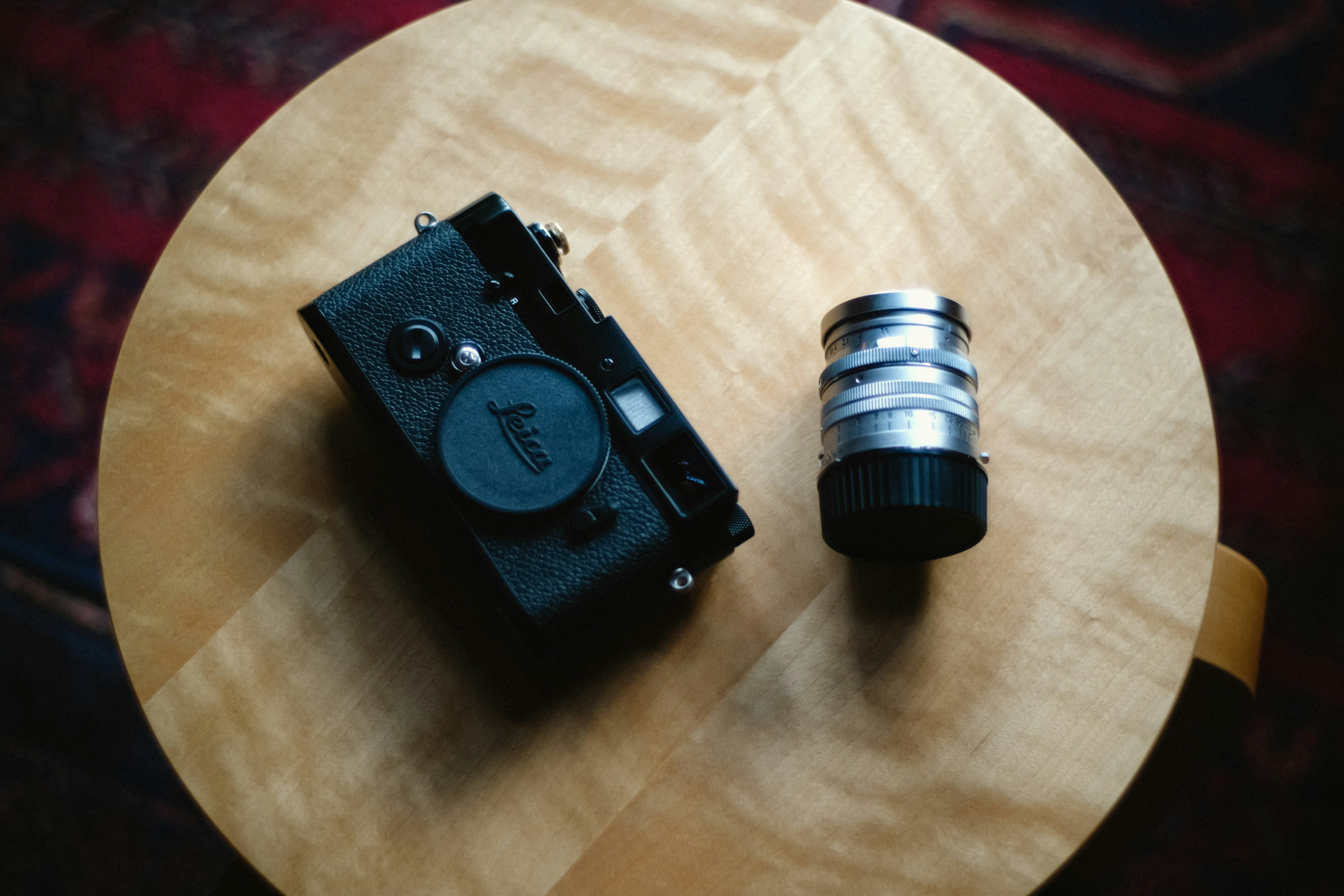 Camera and lens placed on a wooden table