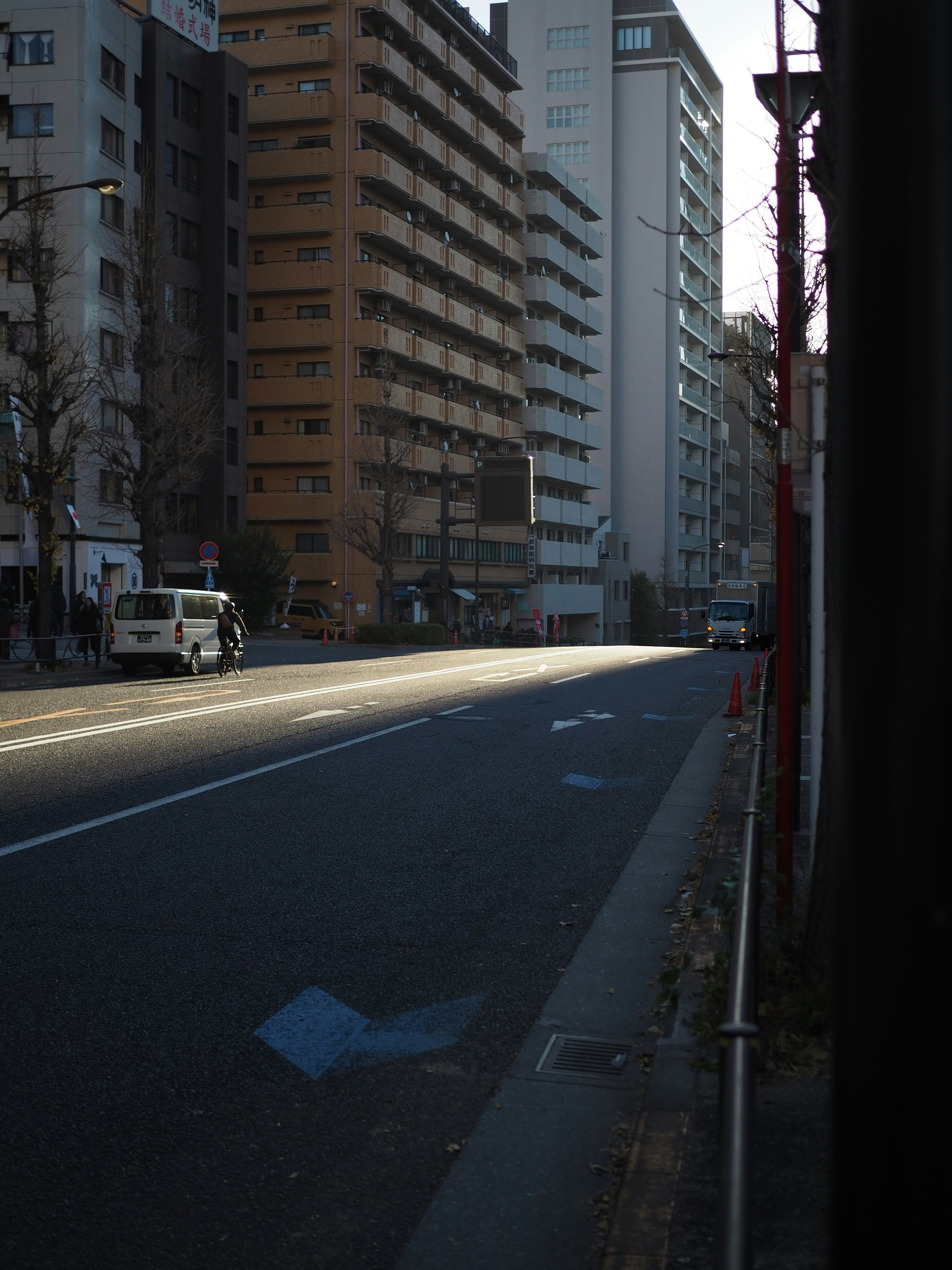 Quiet city street with high-rise buildings and sunlight