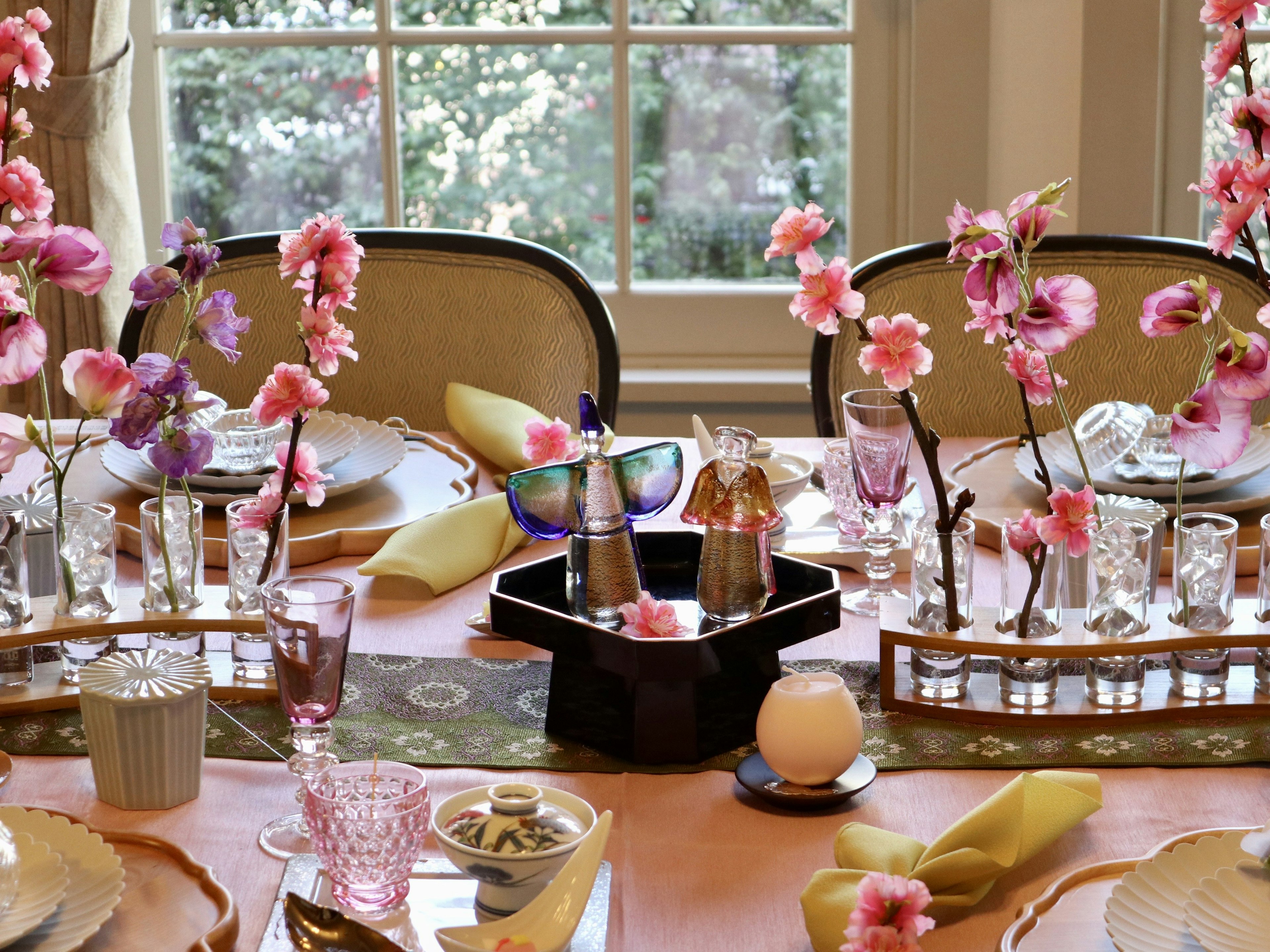 Elegant table setting adorned with vibrant flowers in a bright dining room