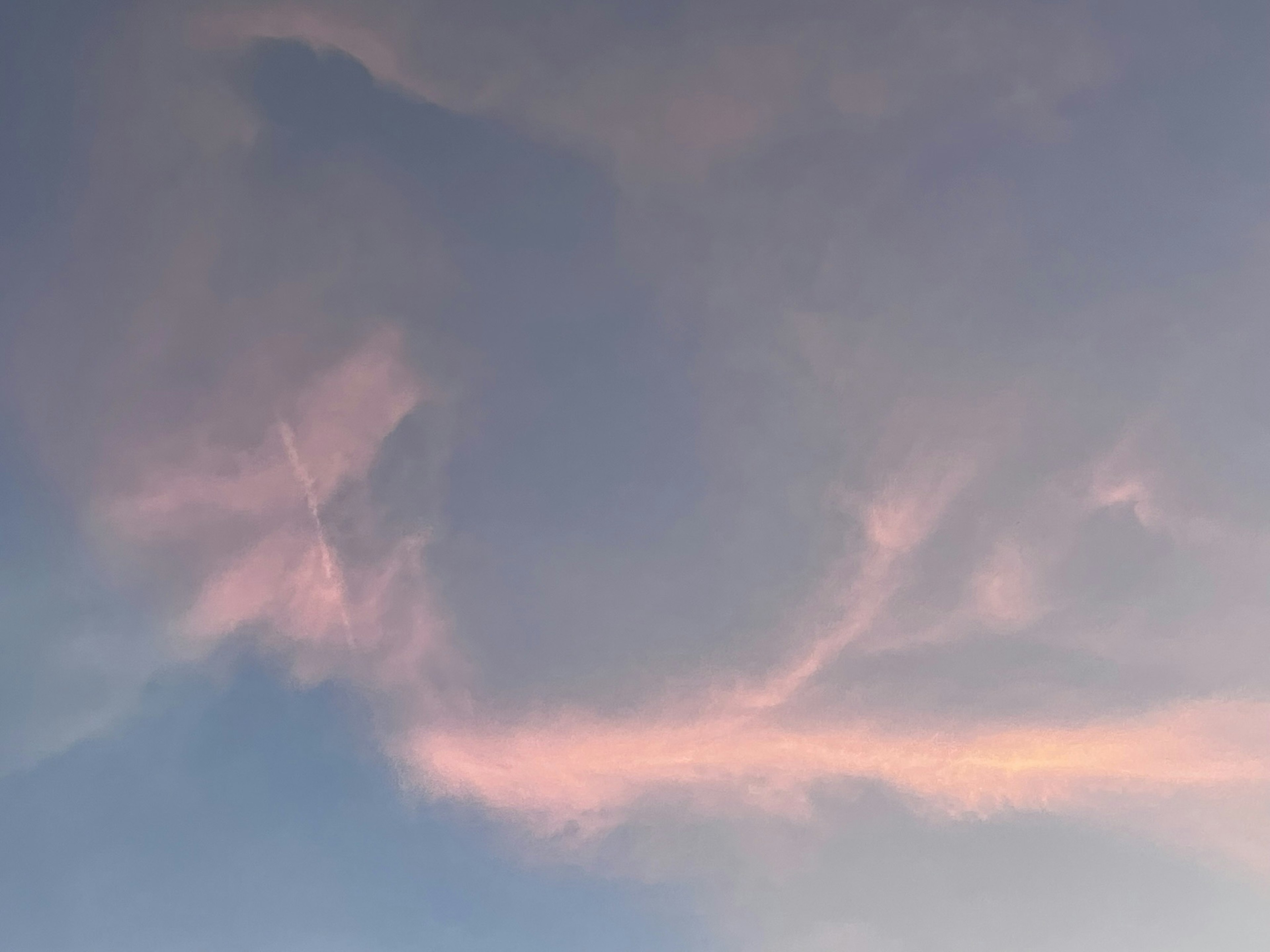 Soft pink and blue sky featuring swirling cloud patterns