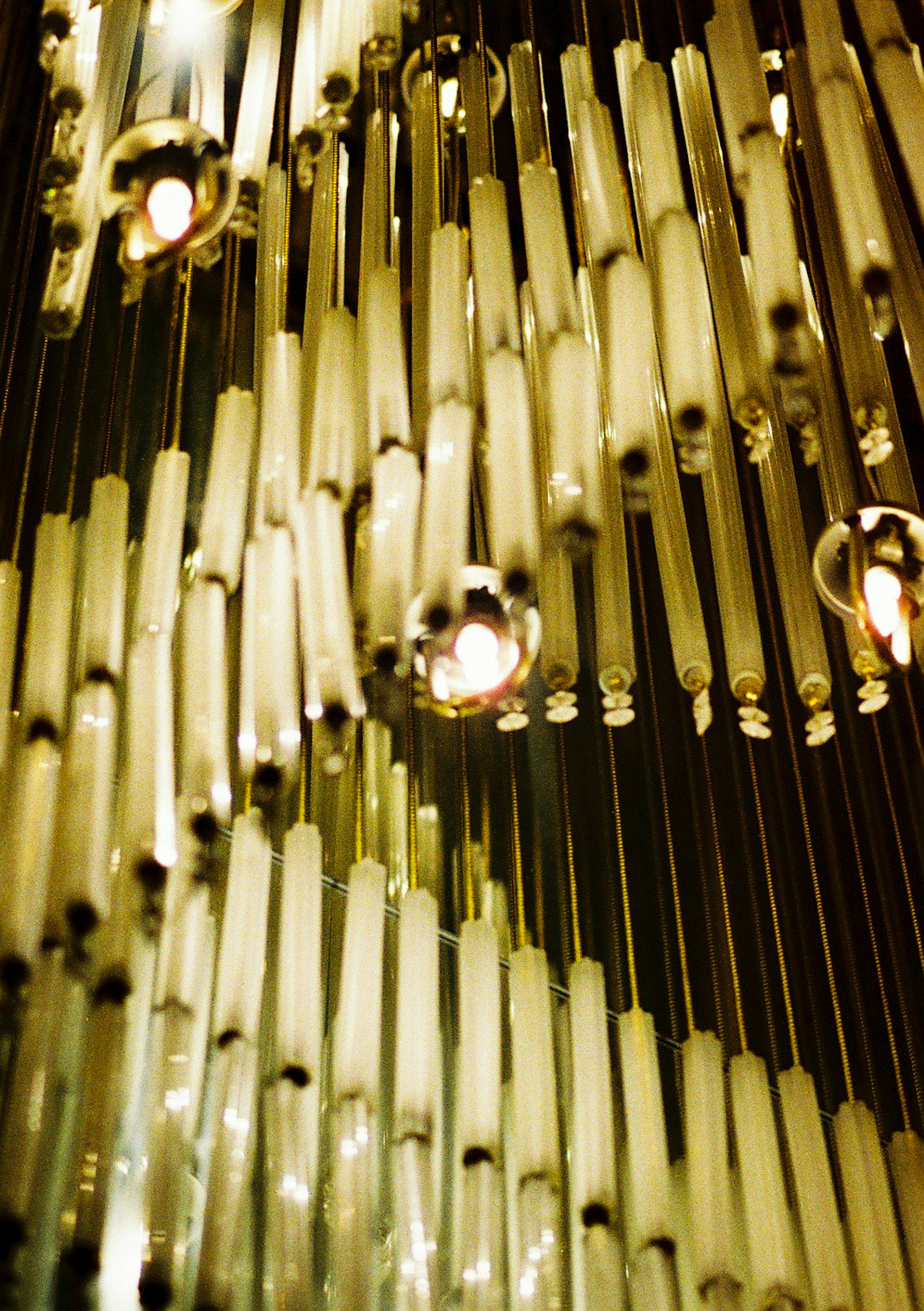 Detailed view of a shiny chandelier featuring gleaming glass strips and spheres