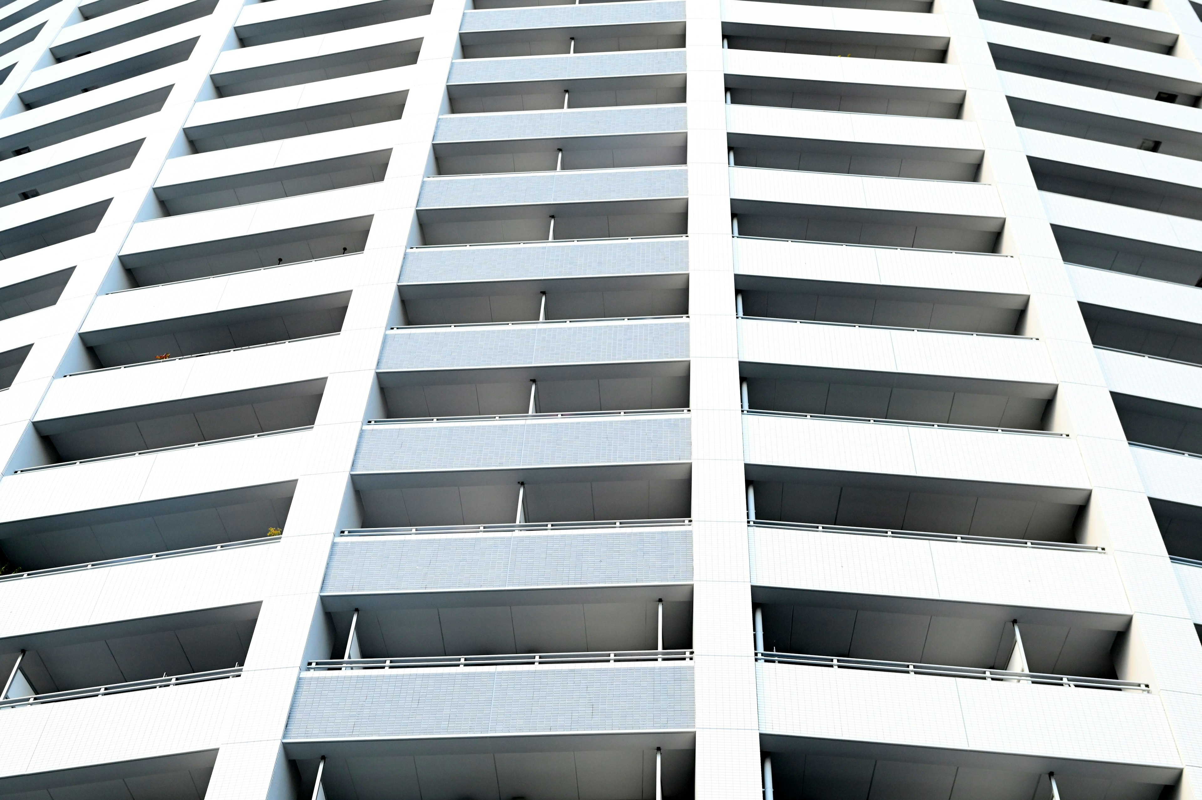 Pattern of circular balconies on a white building facade