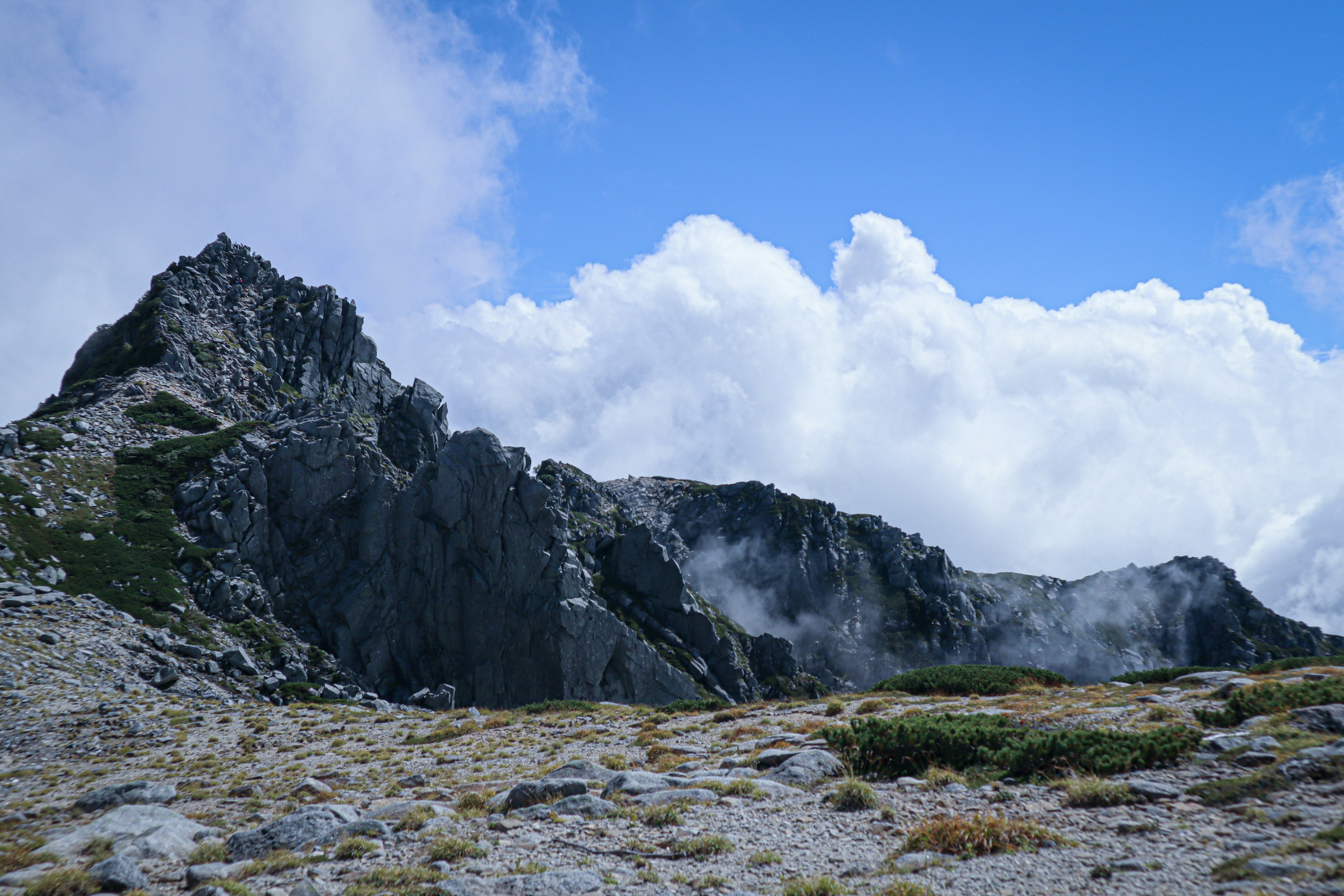 Mountain landscape with clouds and rocky terrain