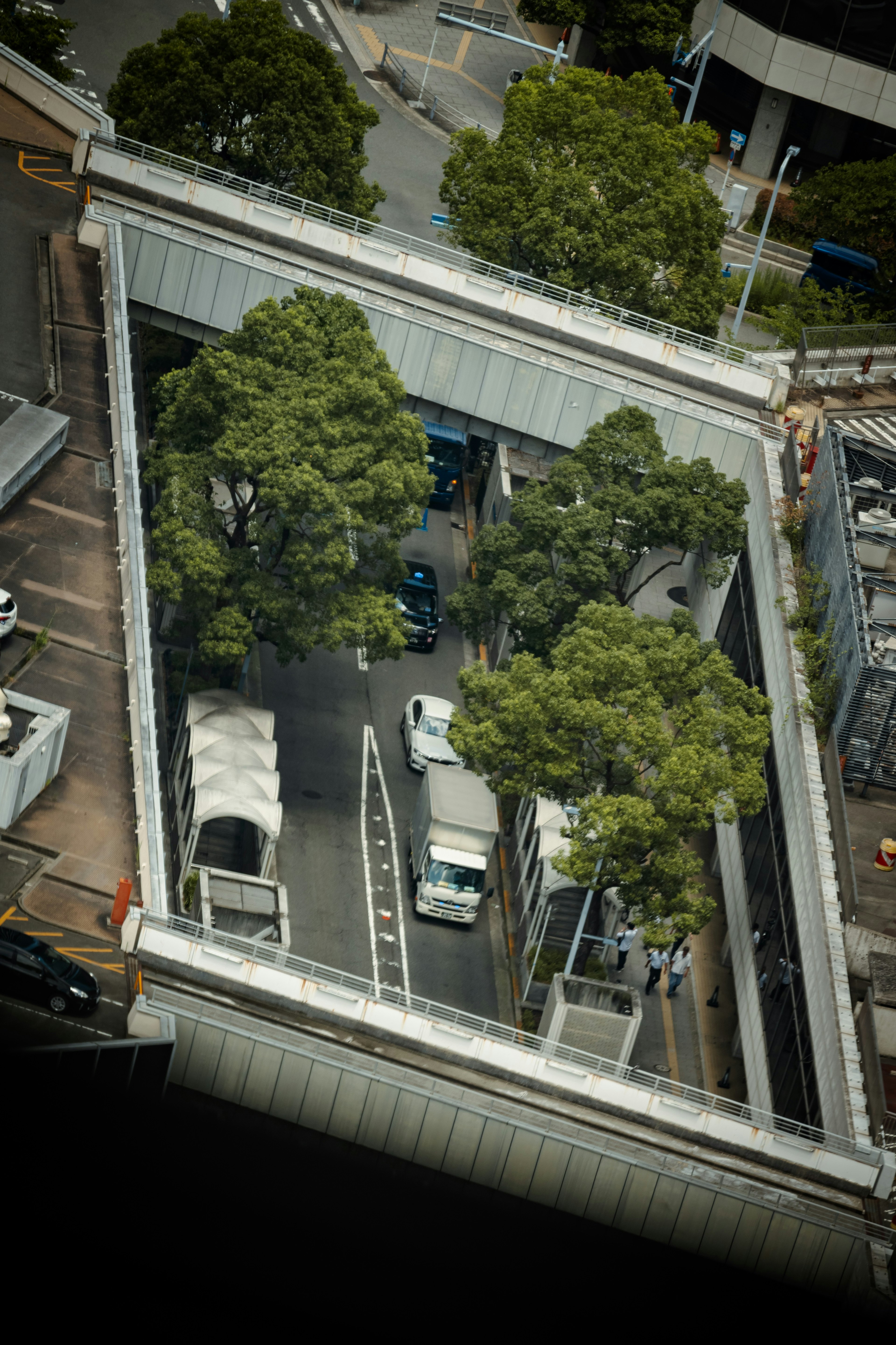 Aerial view of an urban intersection with green trees