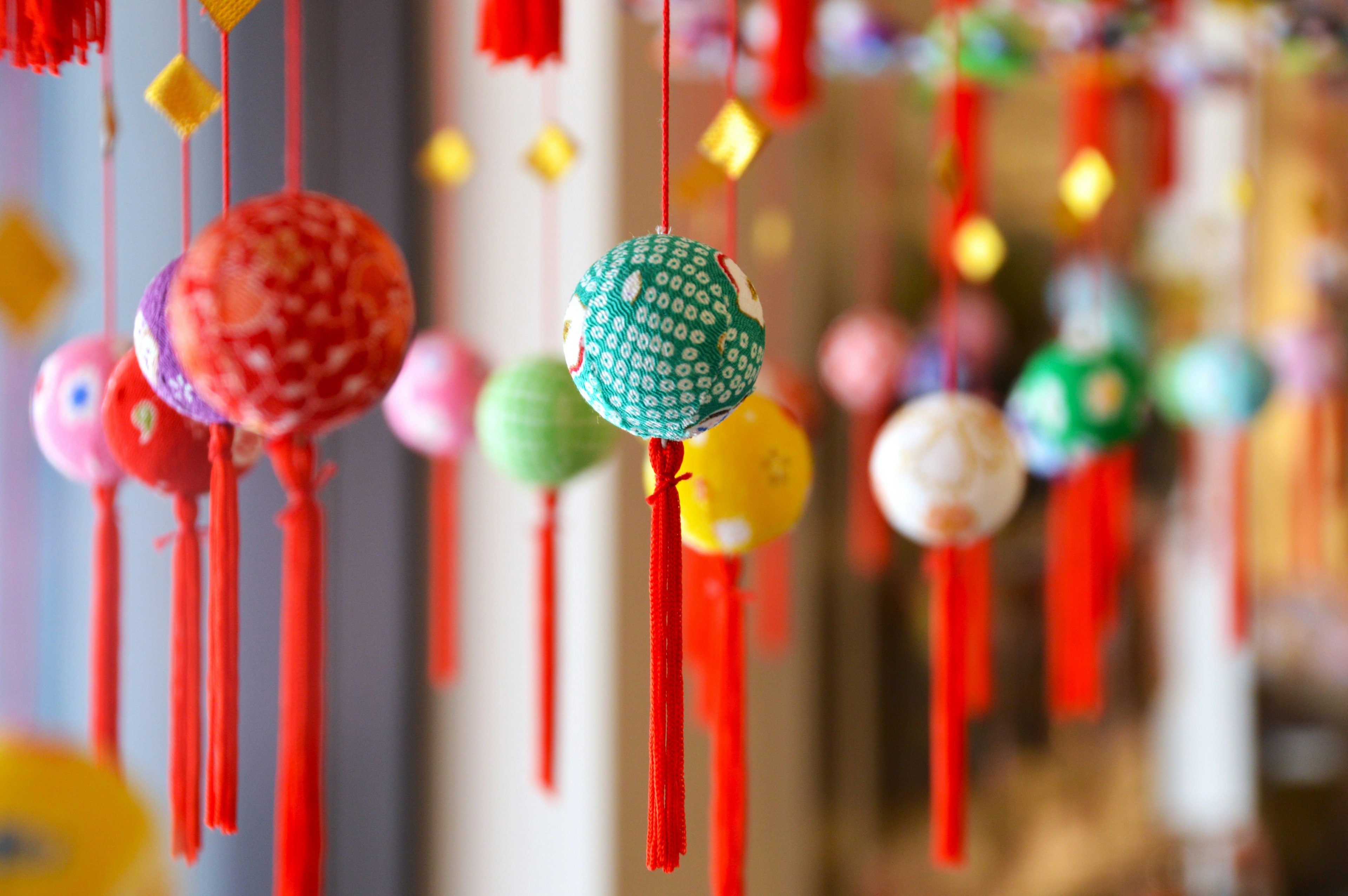 Colorful decorative balls hanging with red tassels