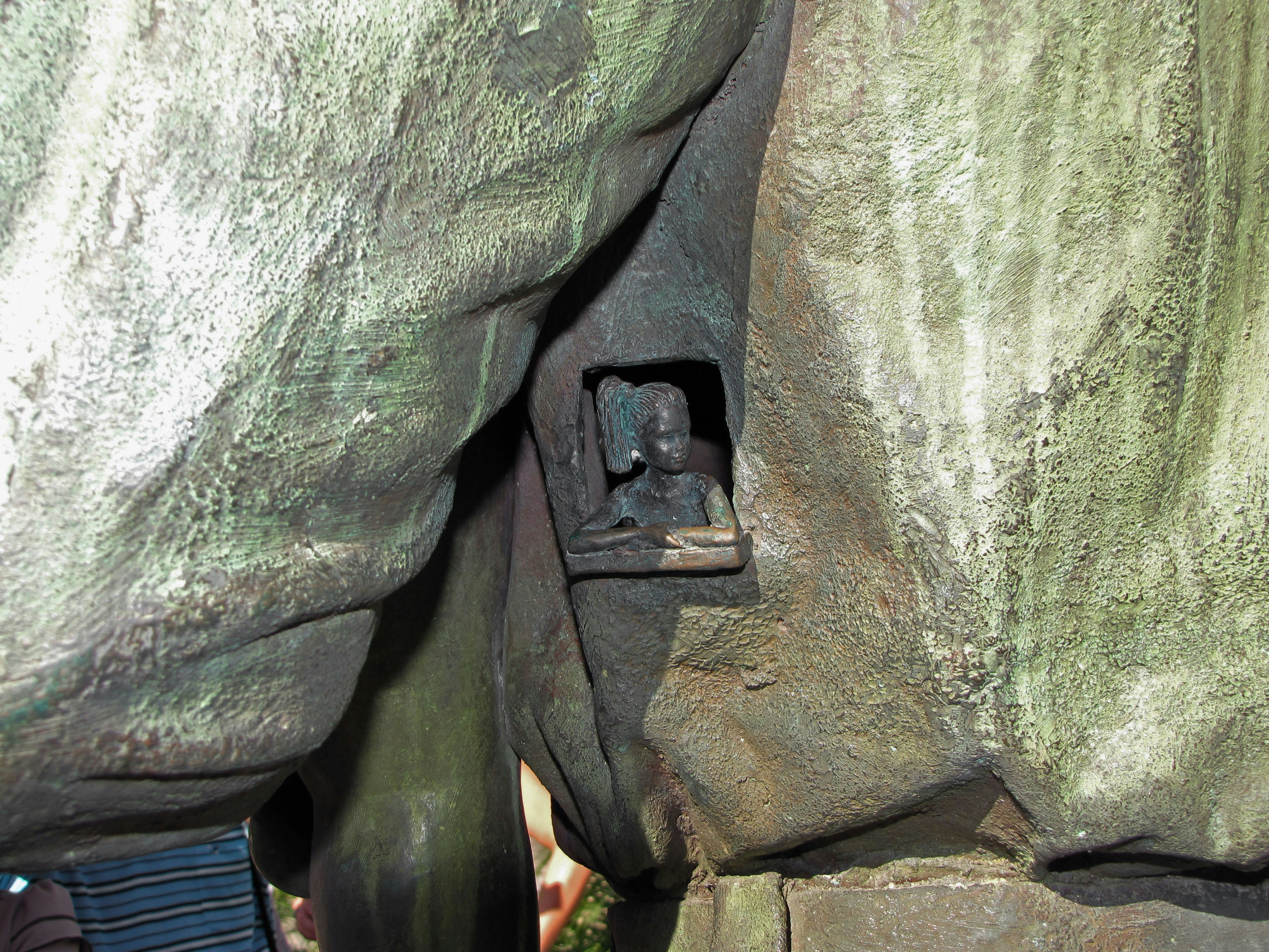 A small statue hidden between rocks