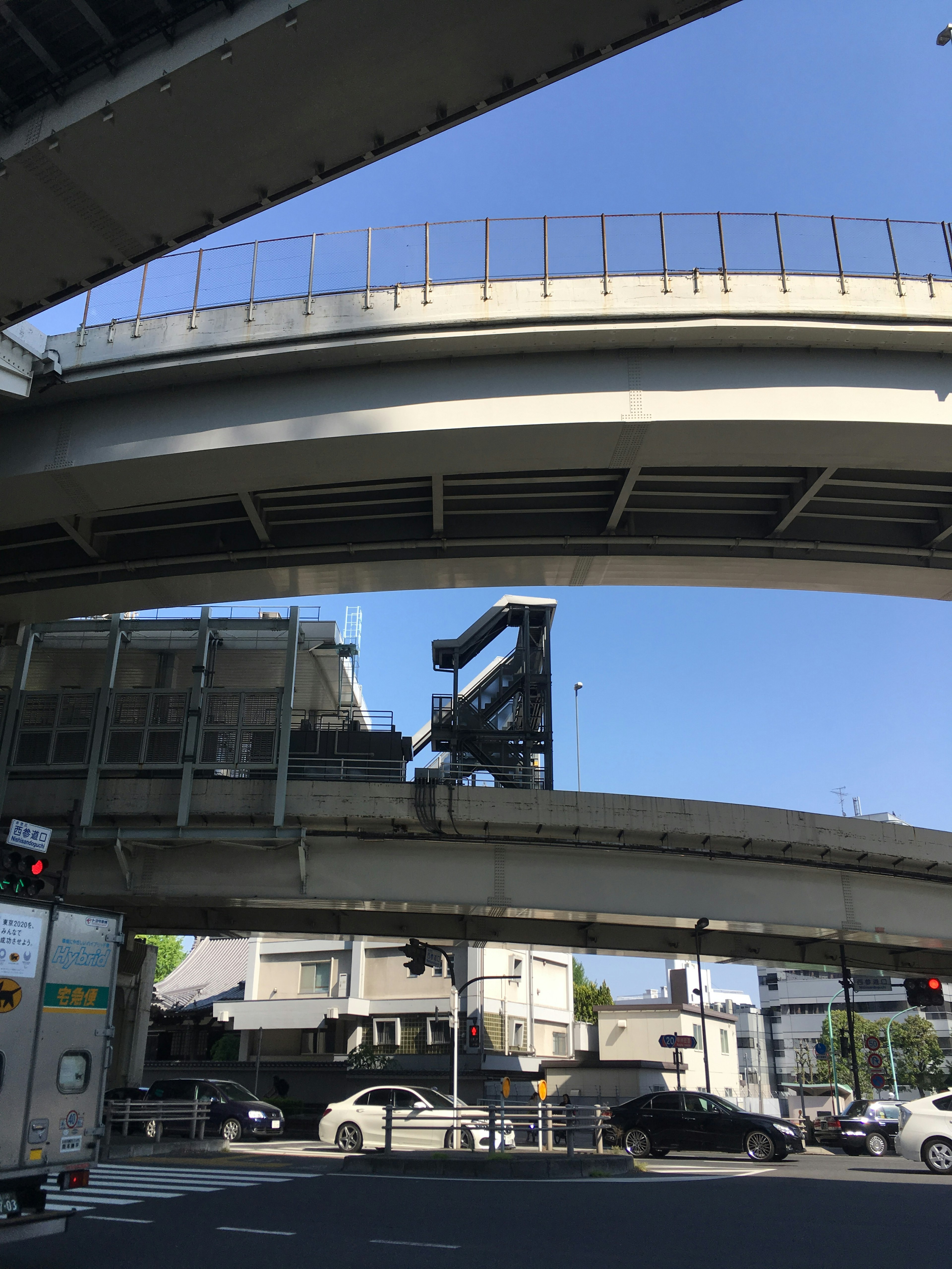 View of elevated roadway and buildings under blue sky