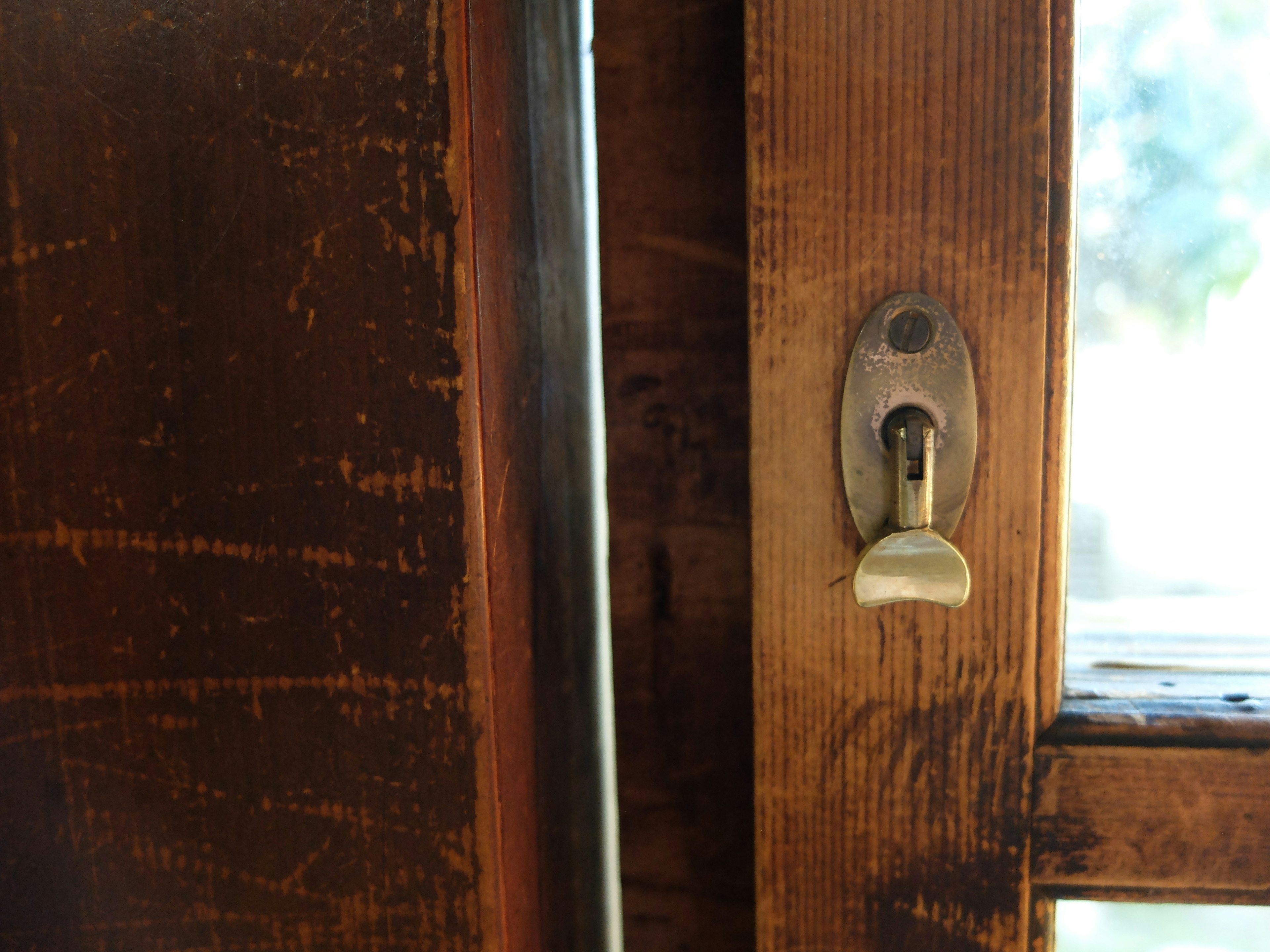 Close-up of a wooden door lock and keyhole