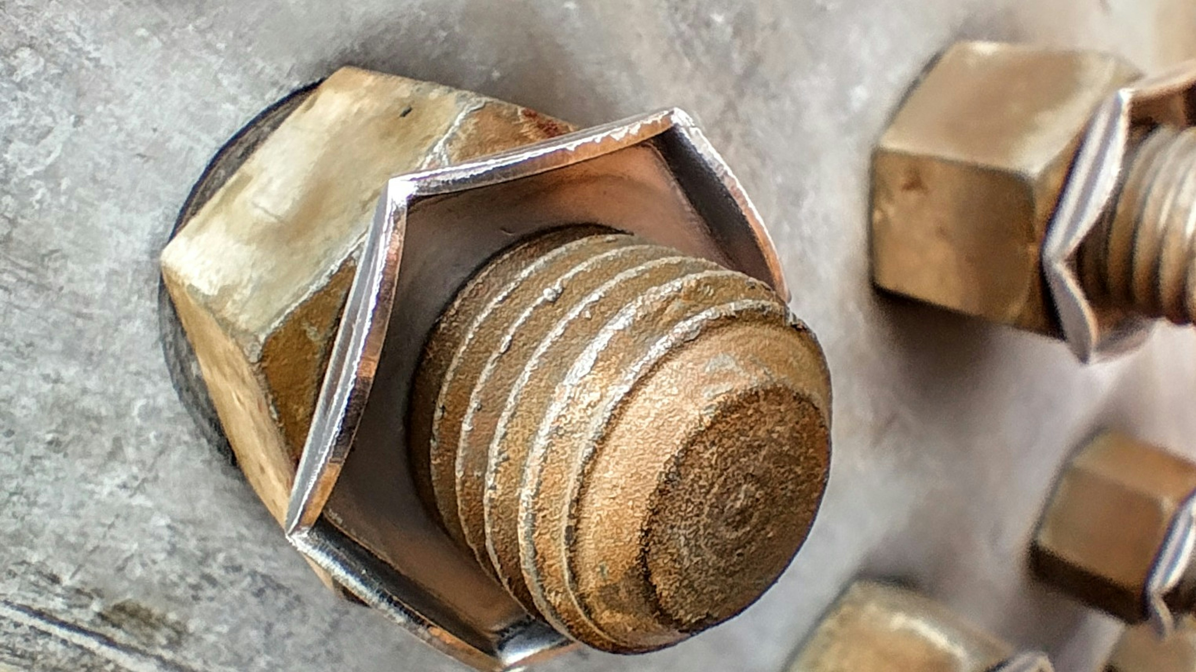 Close-up image of a metal bolt showing copper-colored bolt and nut