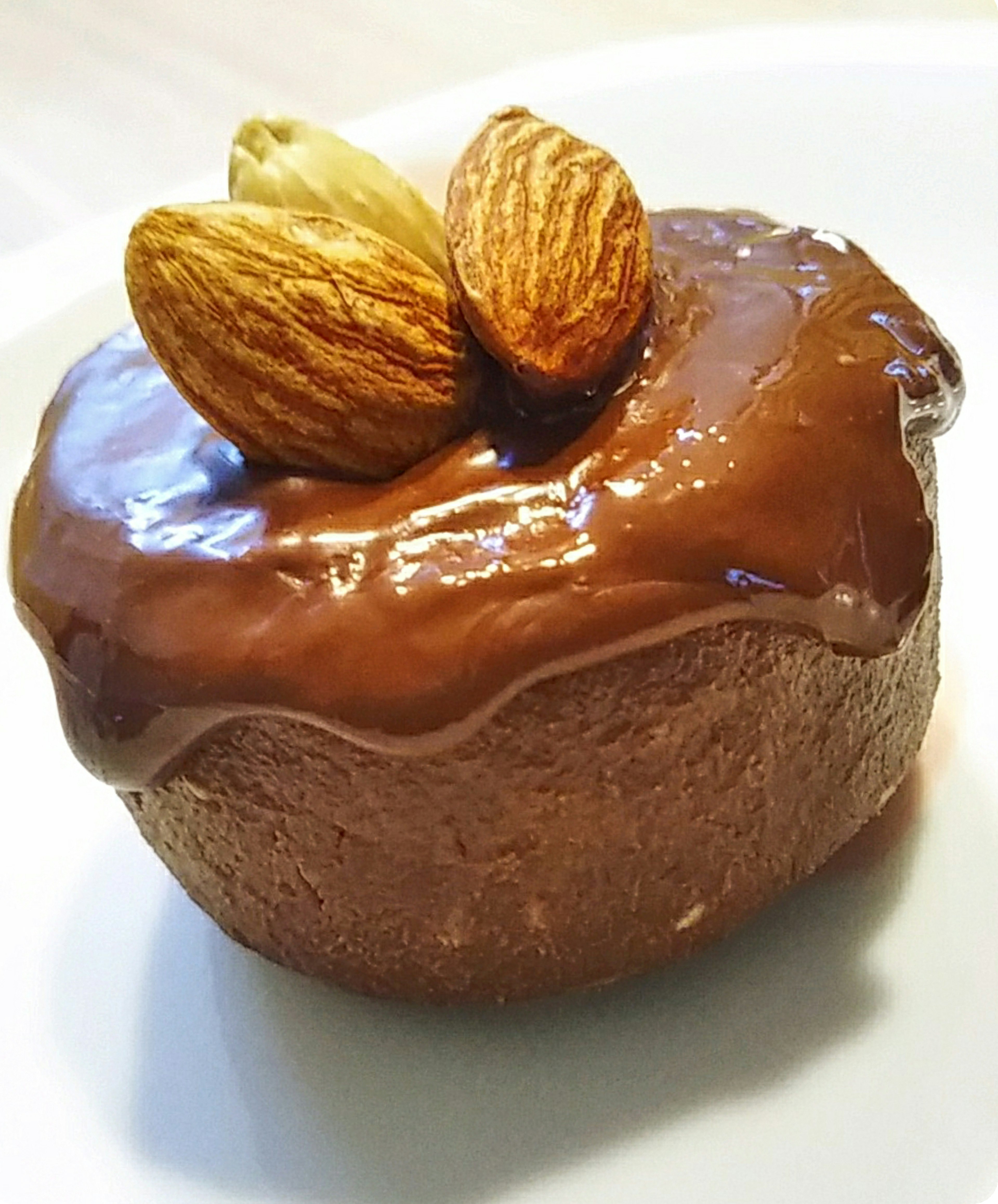 Dessert with chocolate glaze topped with almonds on a cupcake