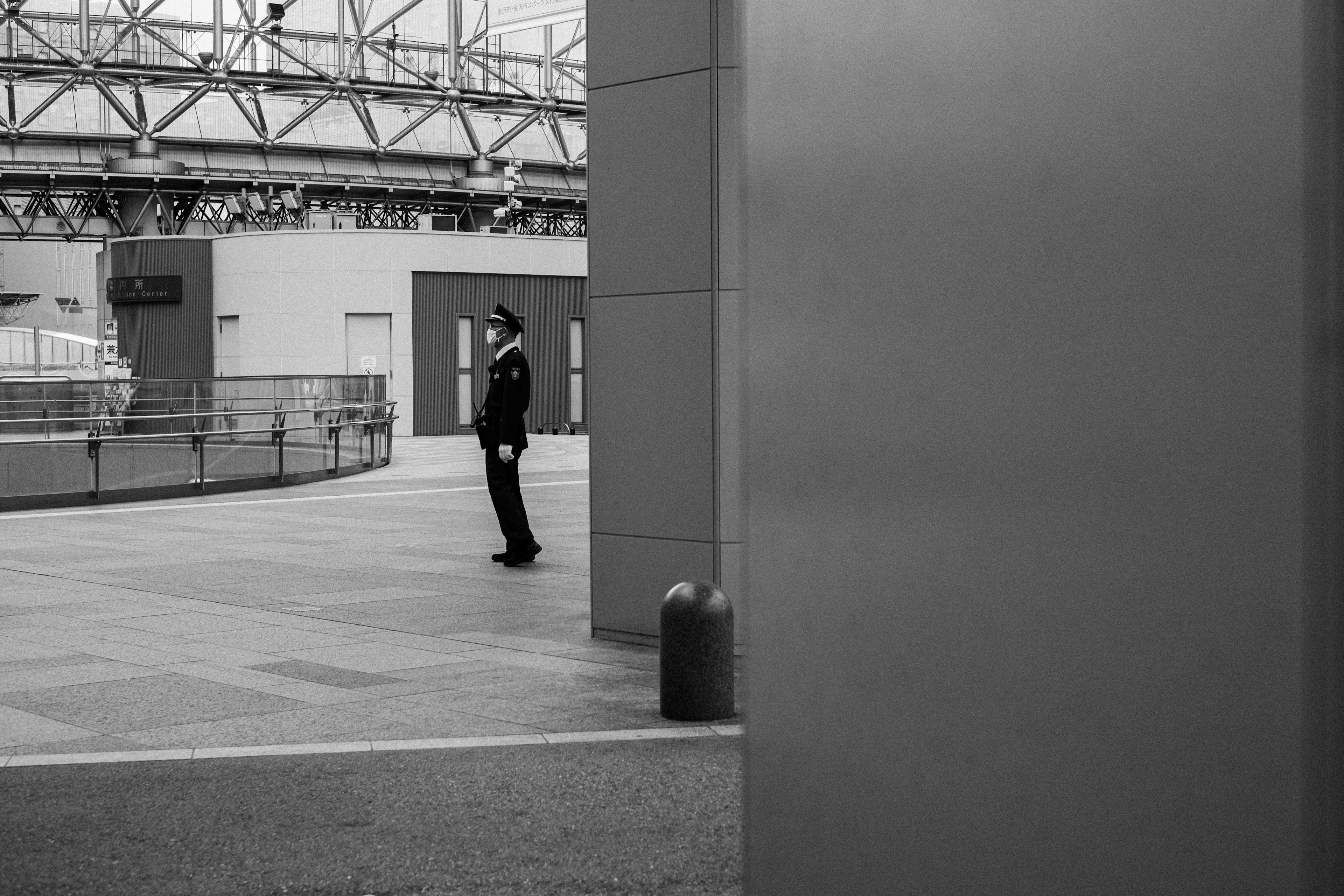 A security guard standing in a black and white scene