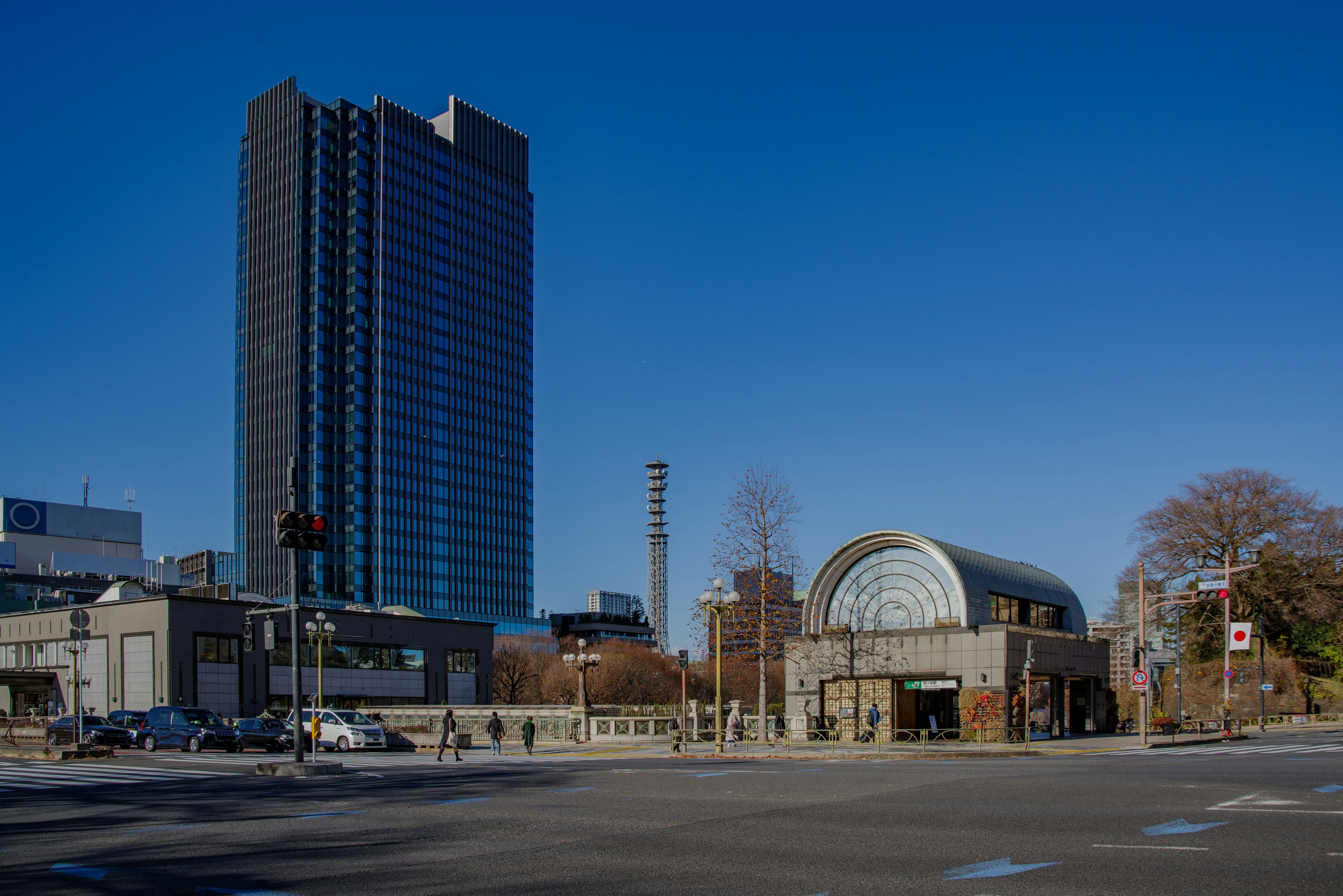 Cityscape featuring a tall building and a modern structure