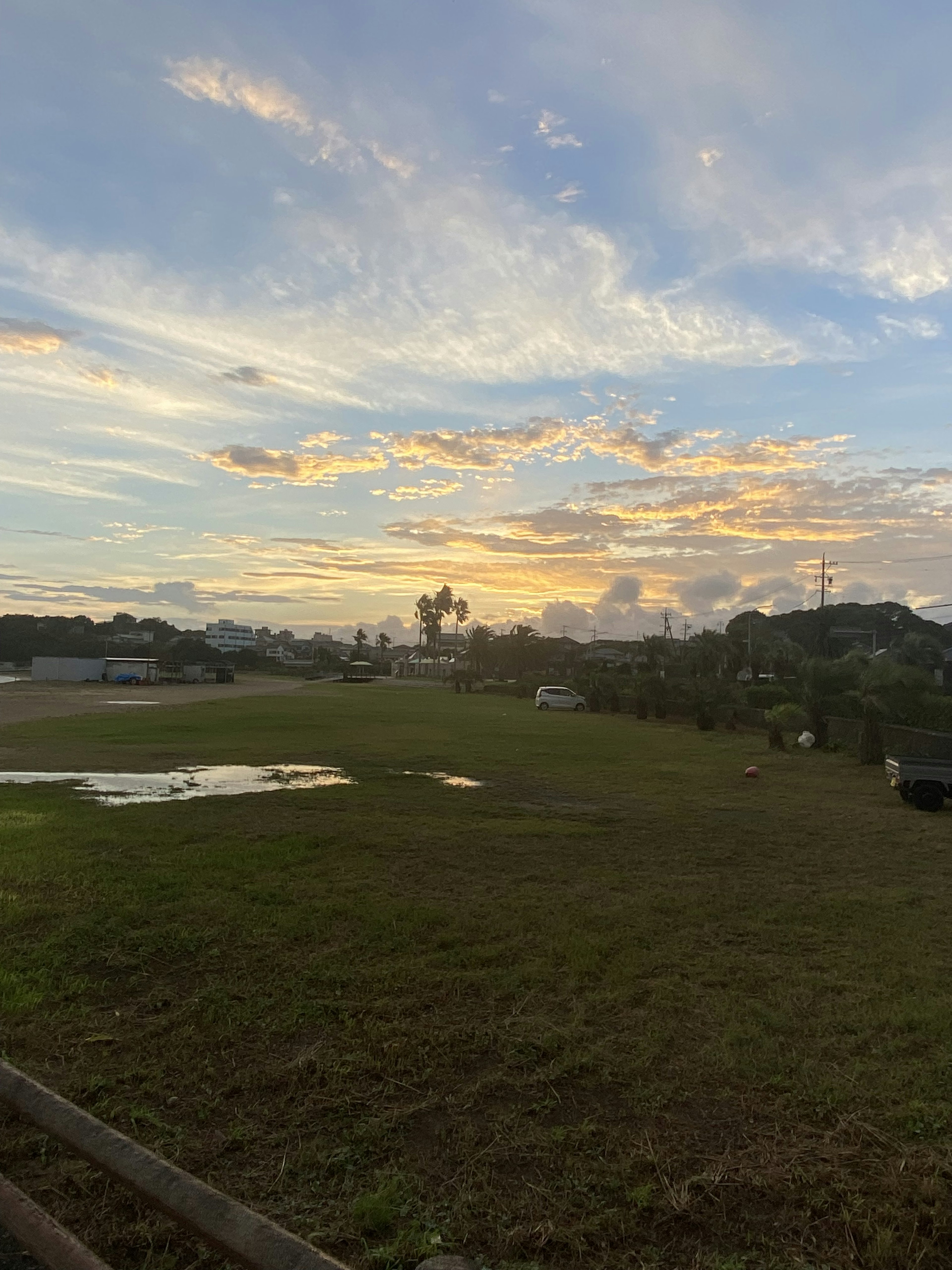 A scenic view of a sunset sky over a green landscape