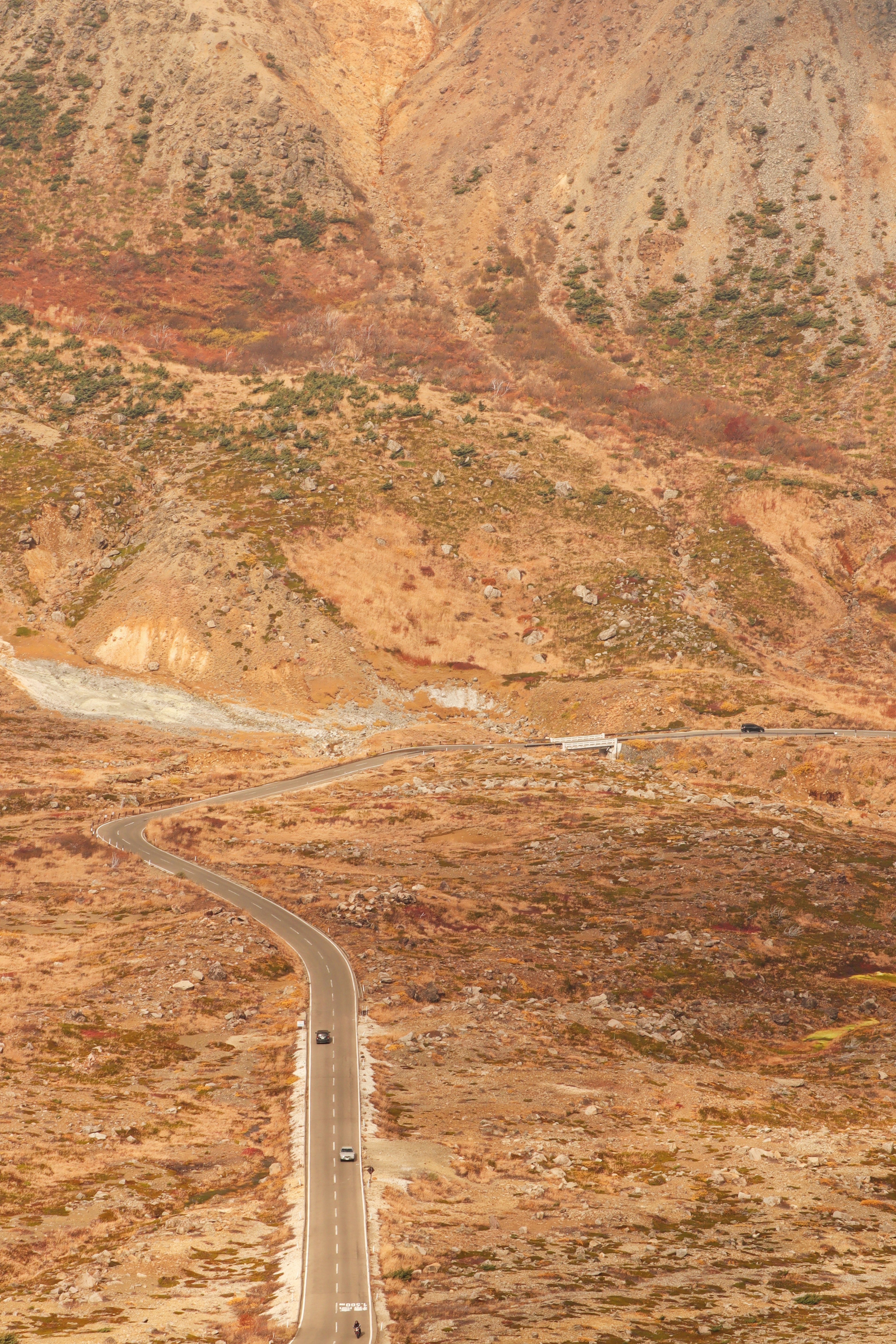 Winding road through mountains with autumn colors in the landscape