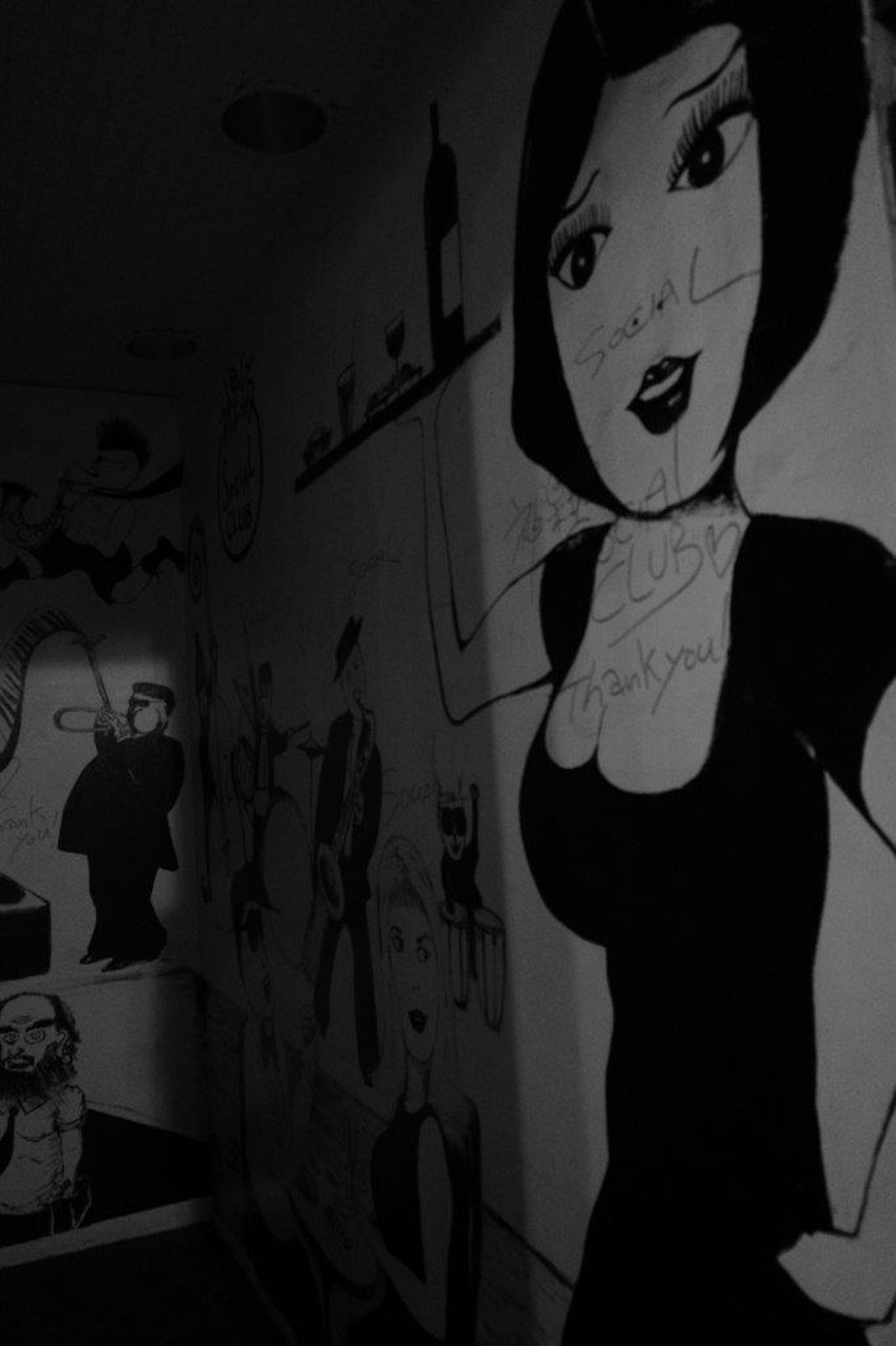 Black and white mural featuring a stylized woman and various characters in the background