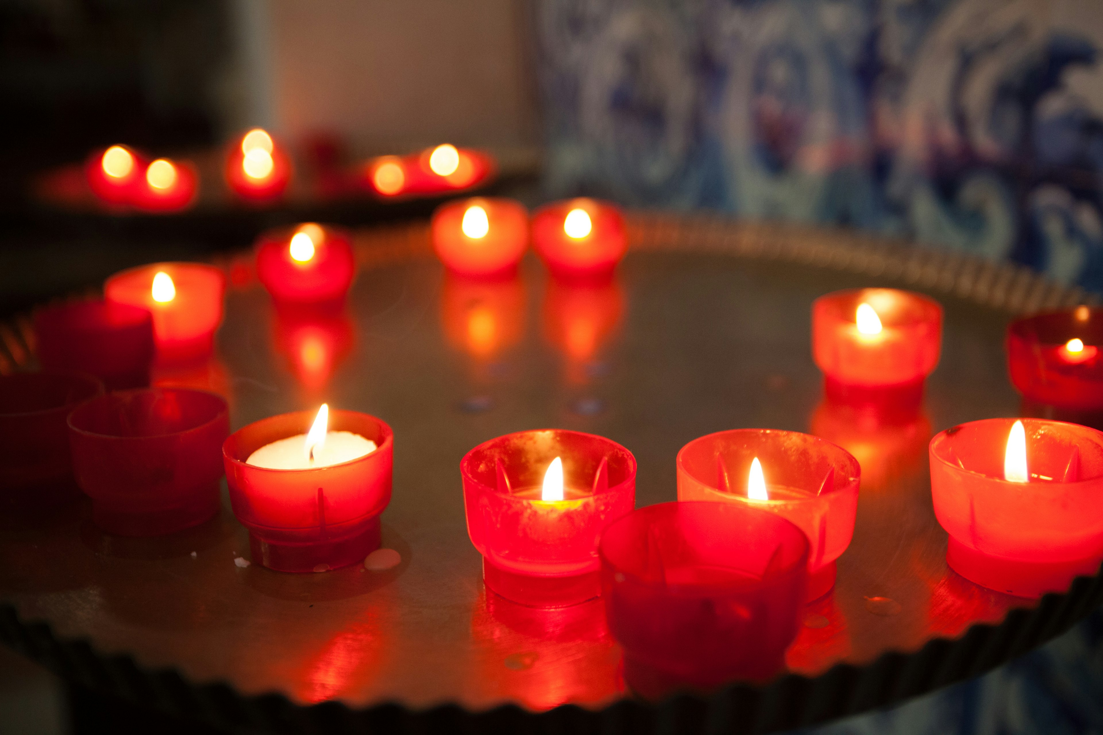 Red candles lit on a table creating a warm ambiance