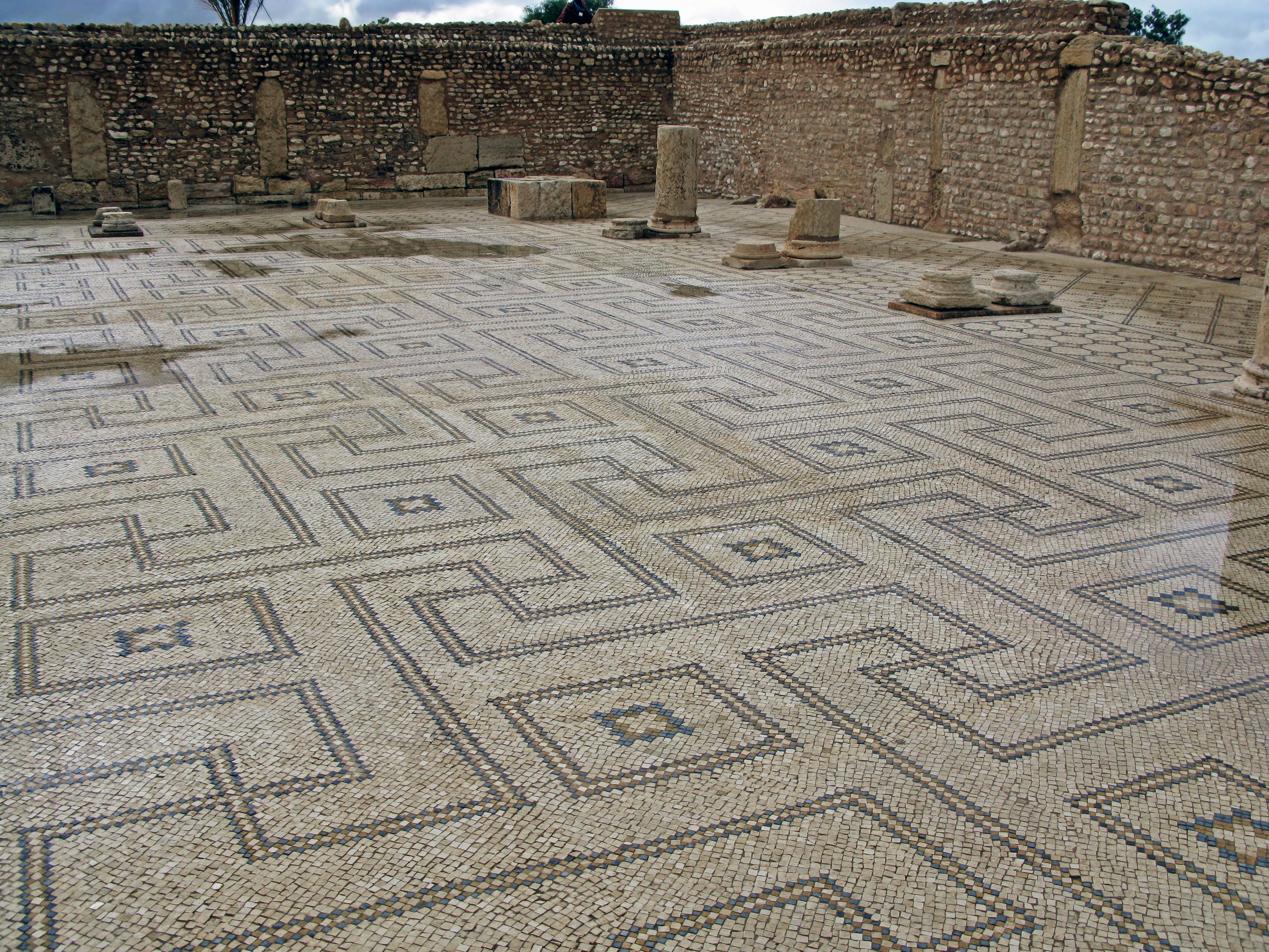 Interior of ancient ruins featuring intricate mosaic tile flooring