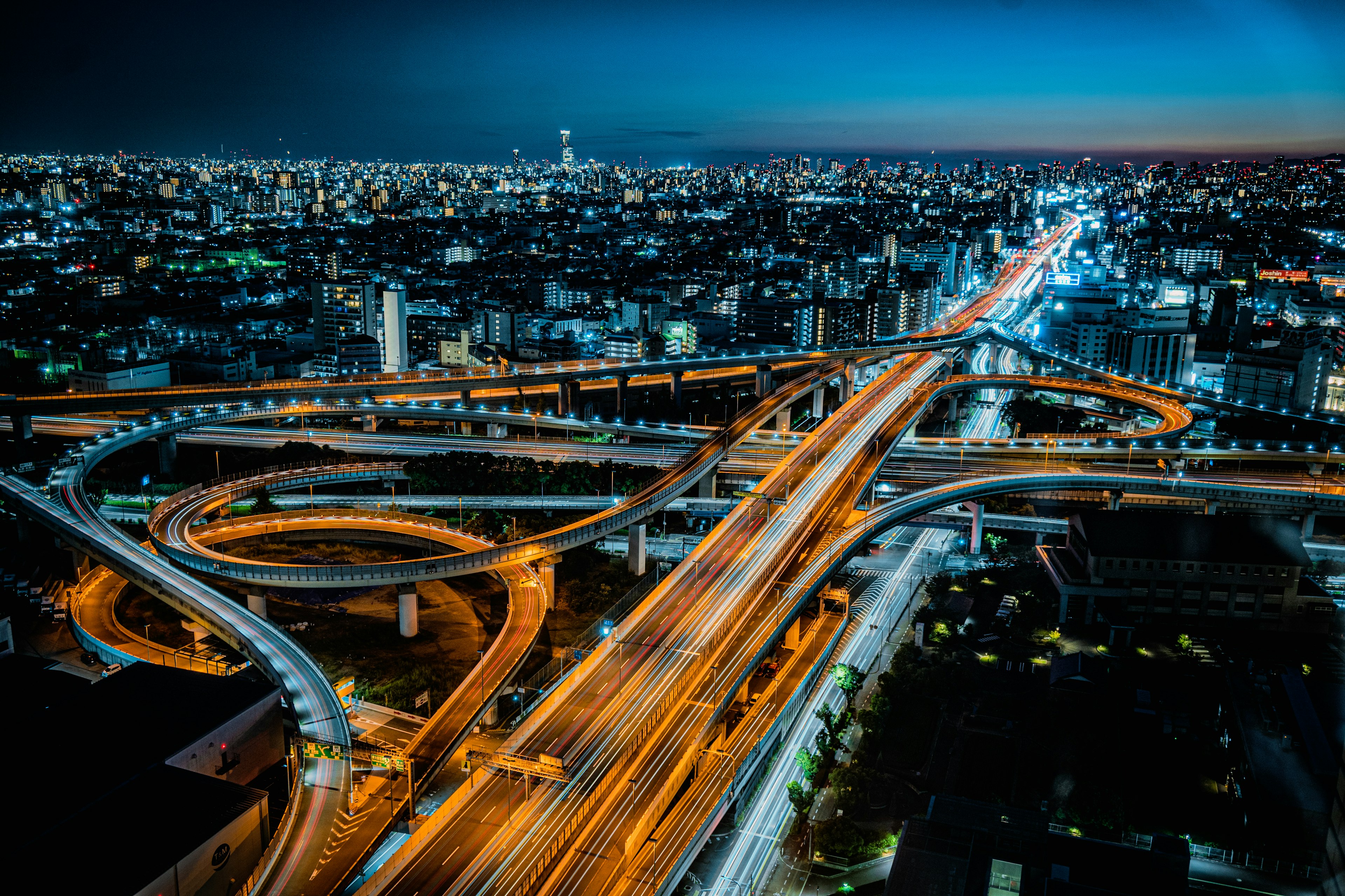 Aerial view of a city at night with intersecting highways