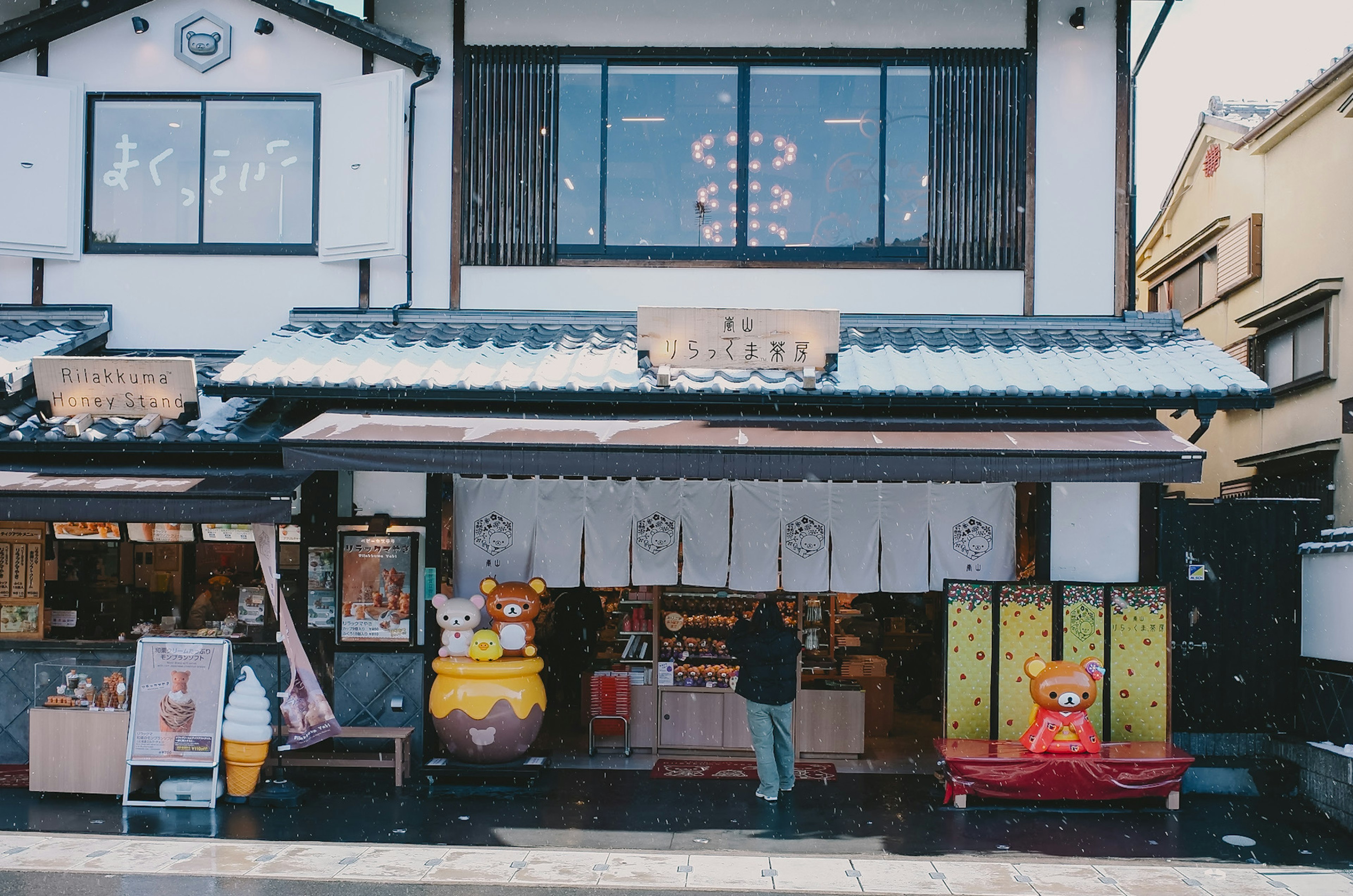 Traditional Japanese shop exterior with colorful decorations in the snow