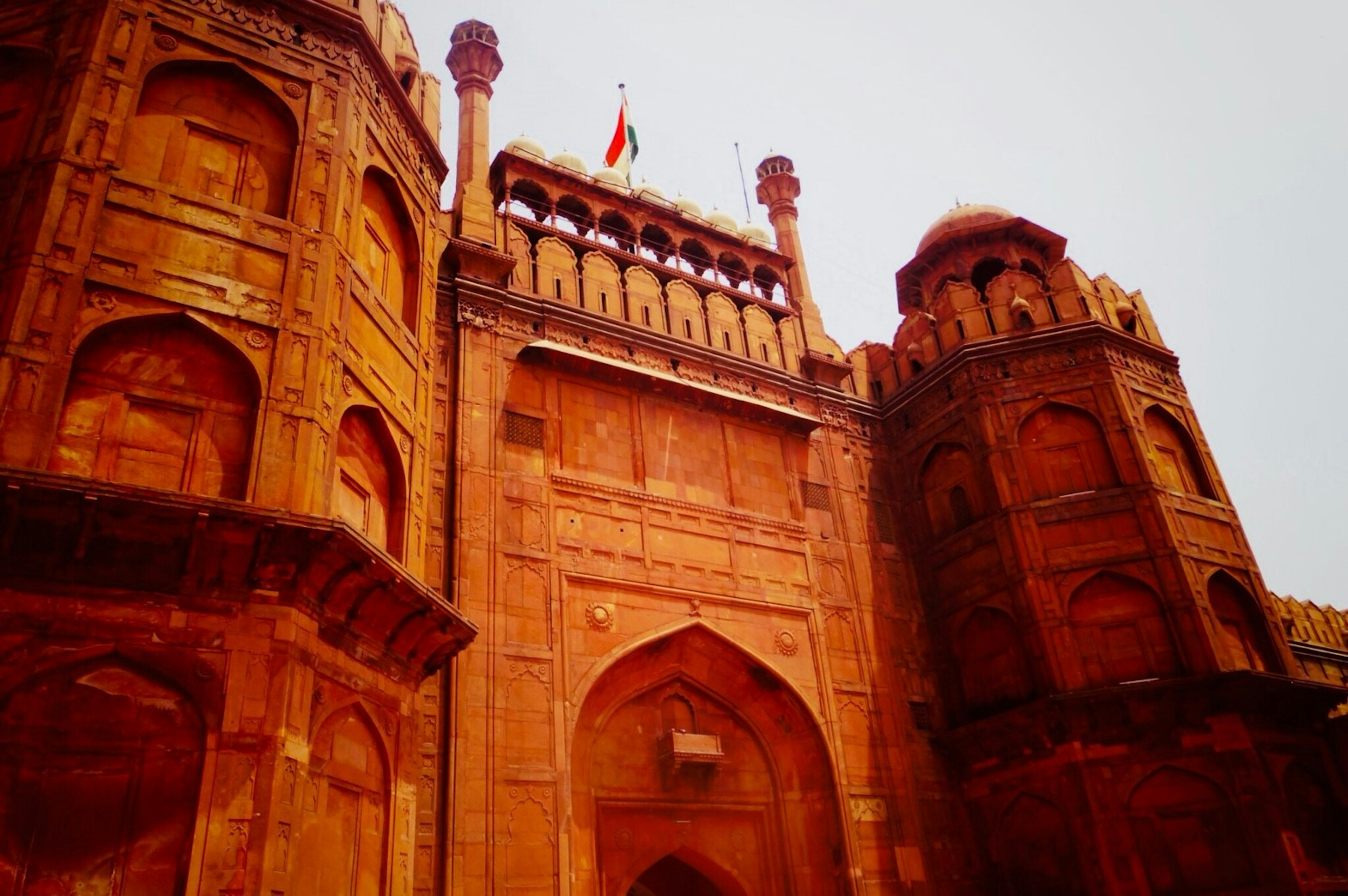 Detailed exterior view of the Red Fort with the Indian flag