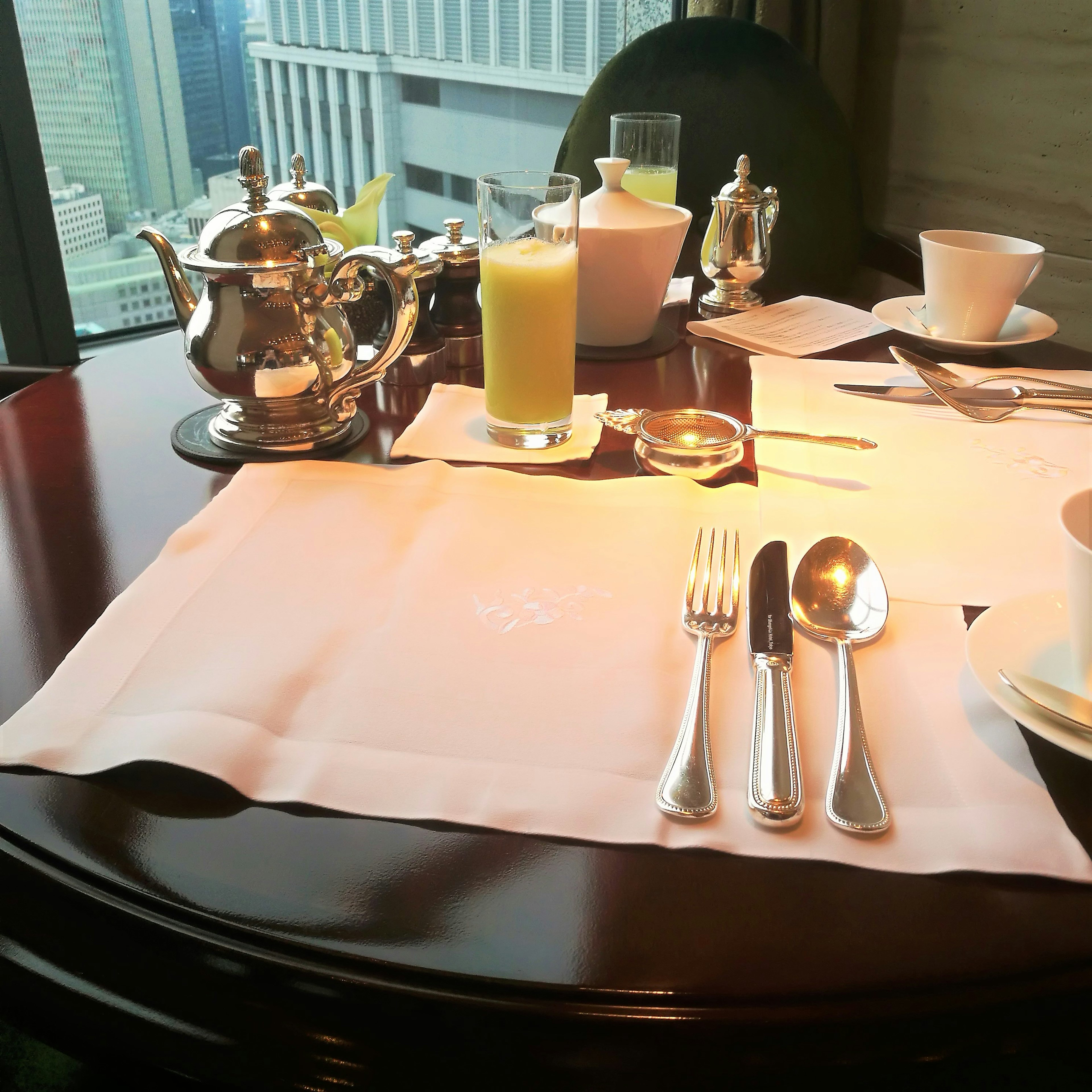 Elegant restaurant table setting featuring tea and juice