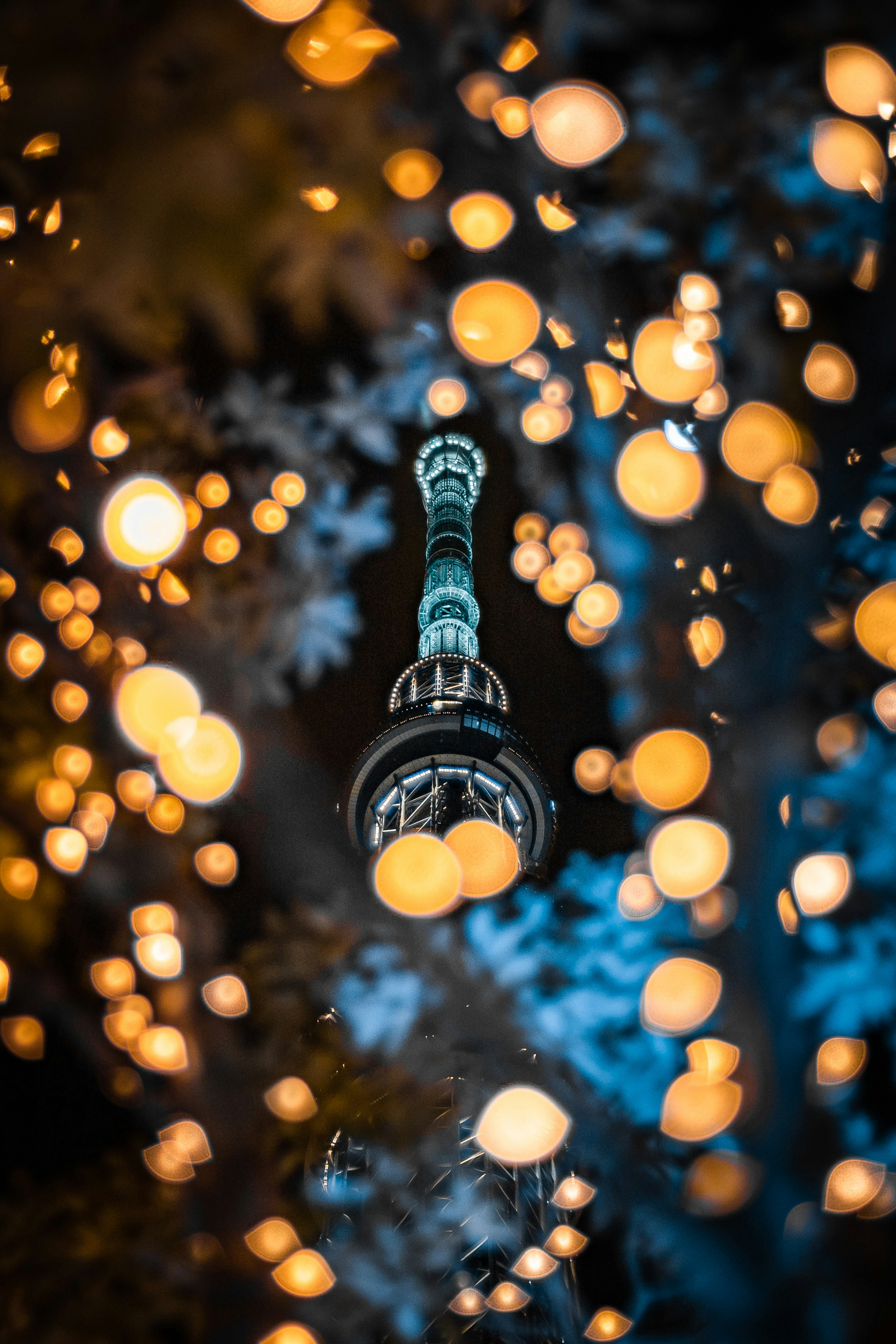 Turm umgeben von leuchtenden Kugeln vor blauem Hintergrund