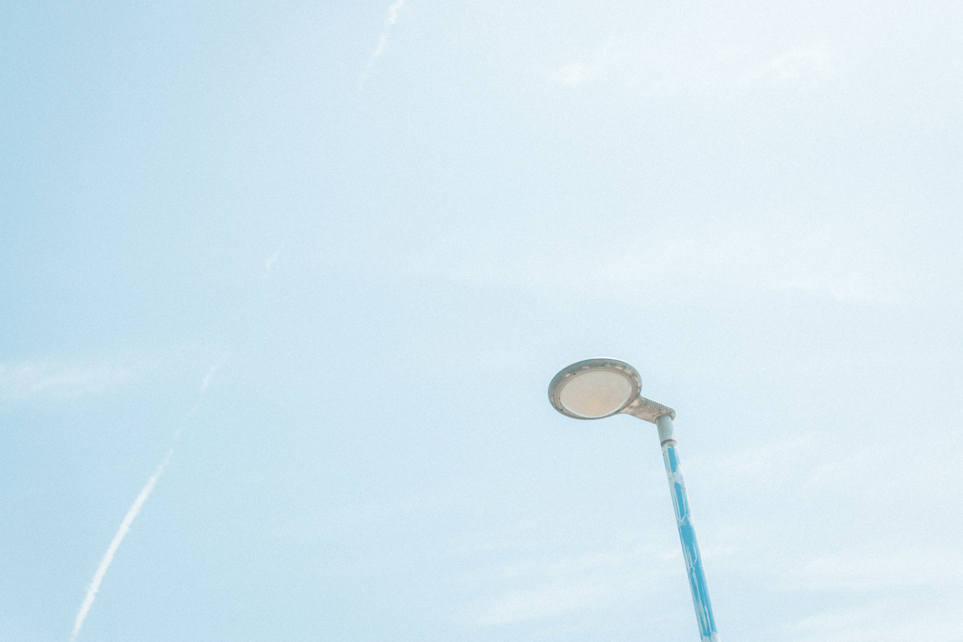 Photo of a streetlight under a blue sky