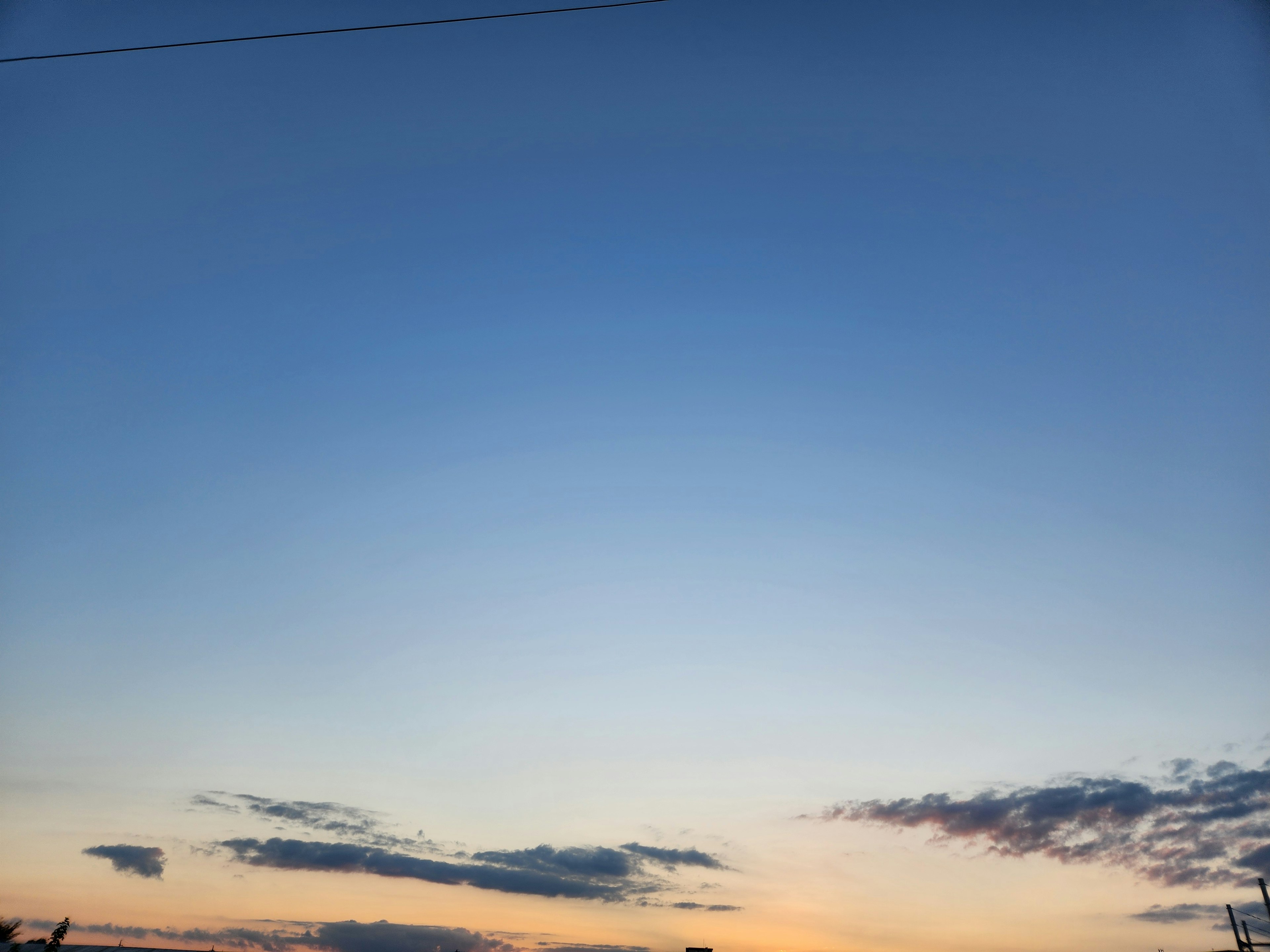 青い空とオレンジ色の夕焼けが広がる風景