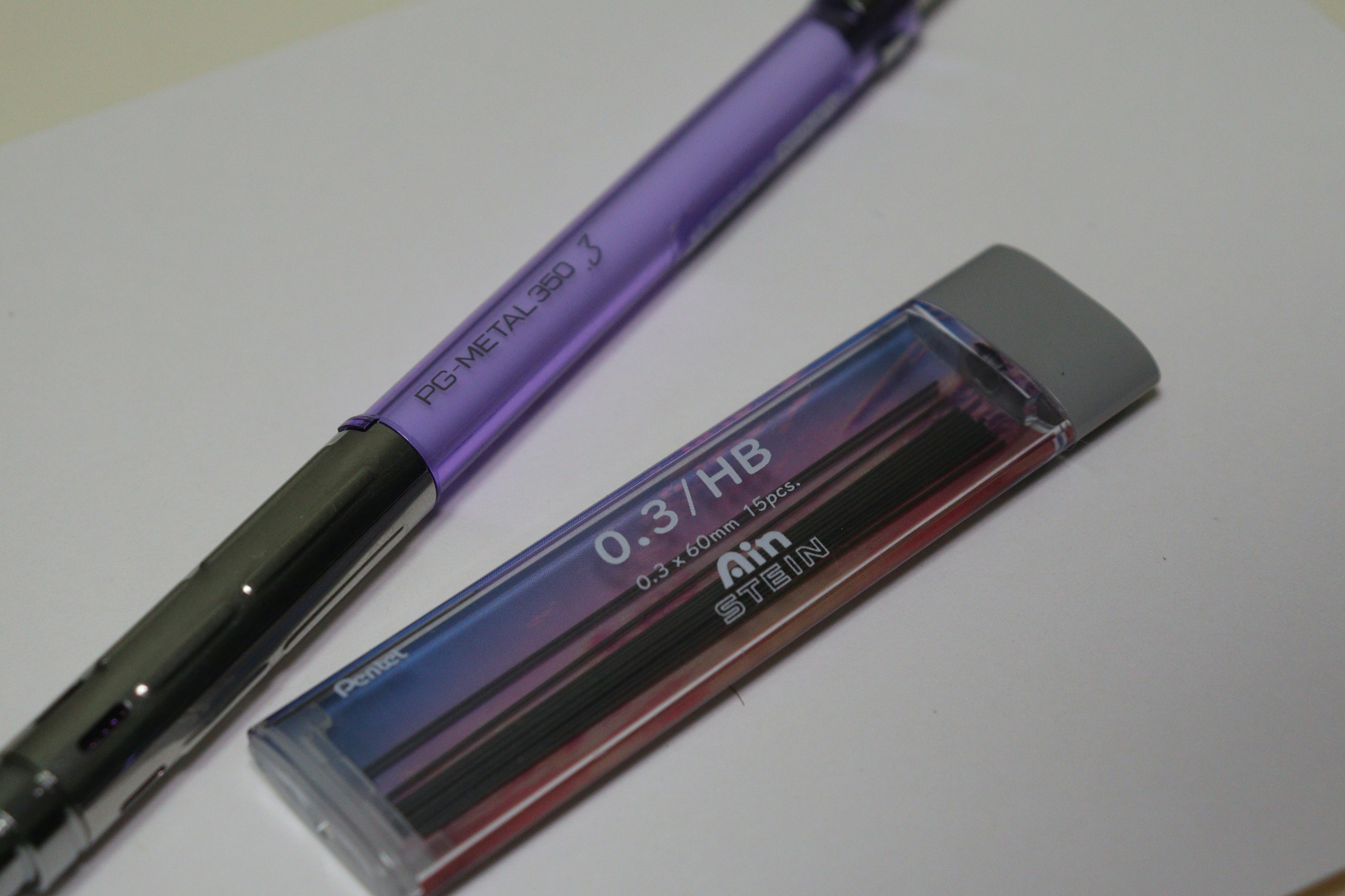 Image of a purple ballpoint pen and a colorful eraser