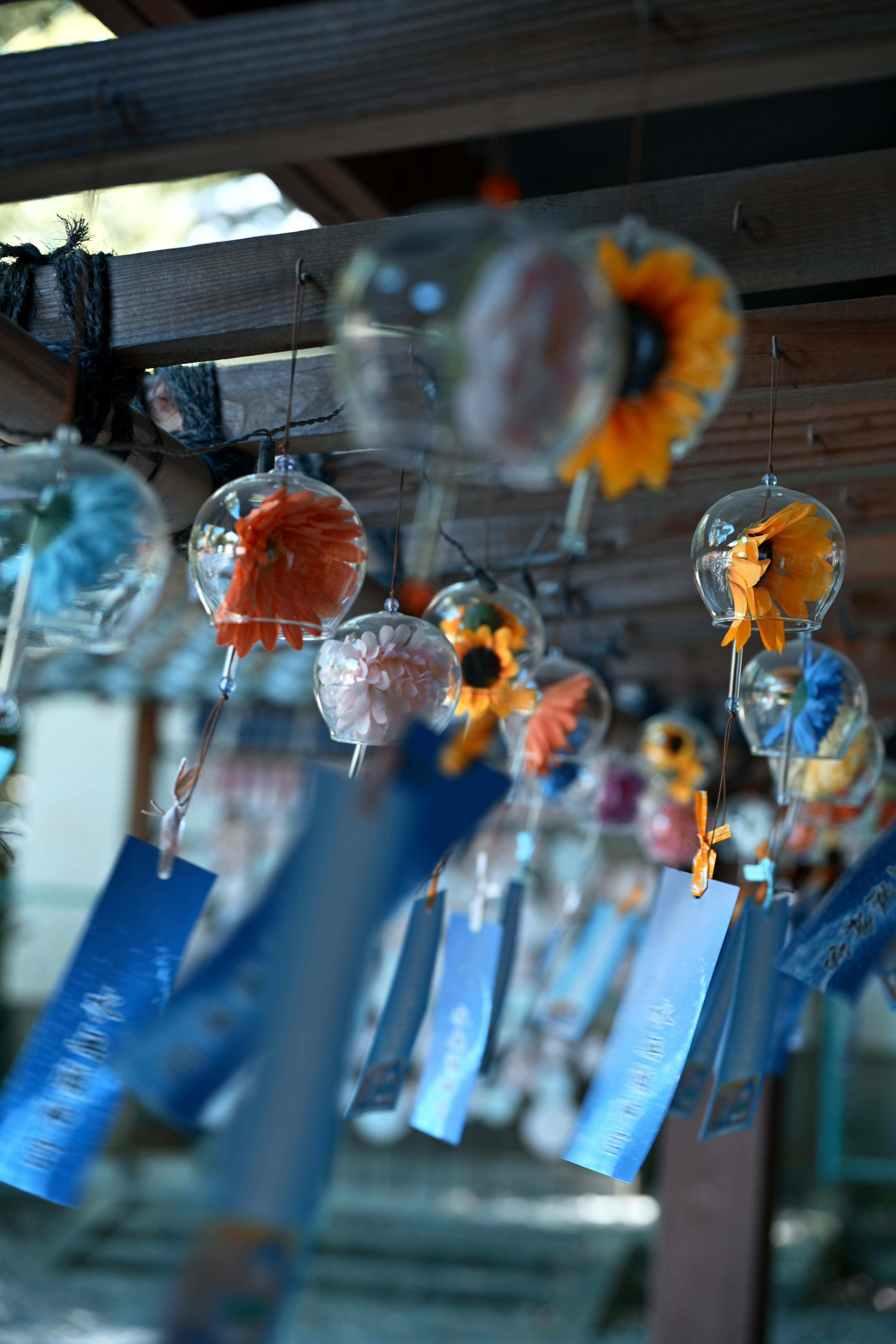 Colorful wind chimes hanging with blue strips below