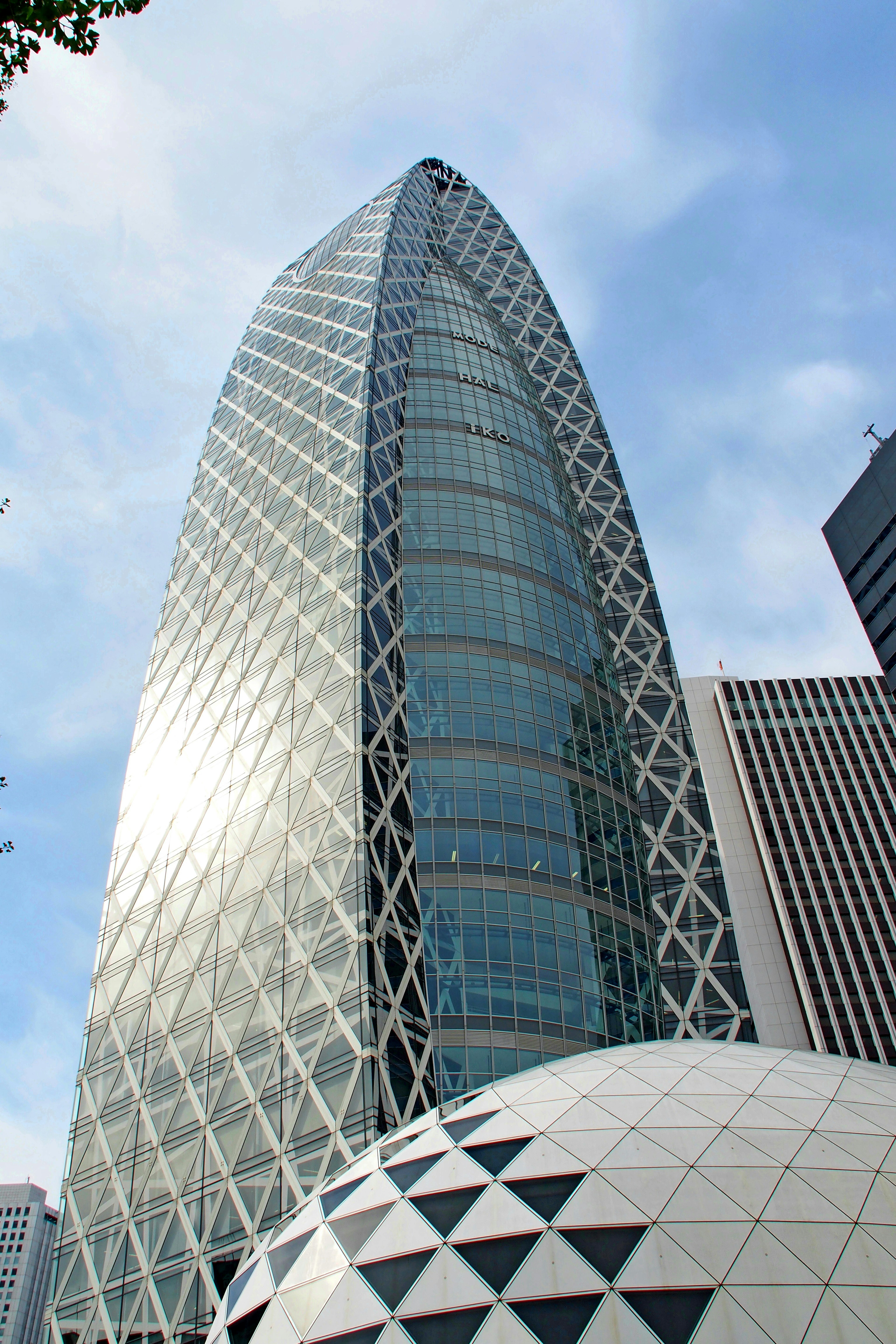 Arquitectura moderna de la Ciudad de la Ópera de Shinjuku con fachada de vidrio y metal