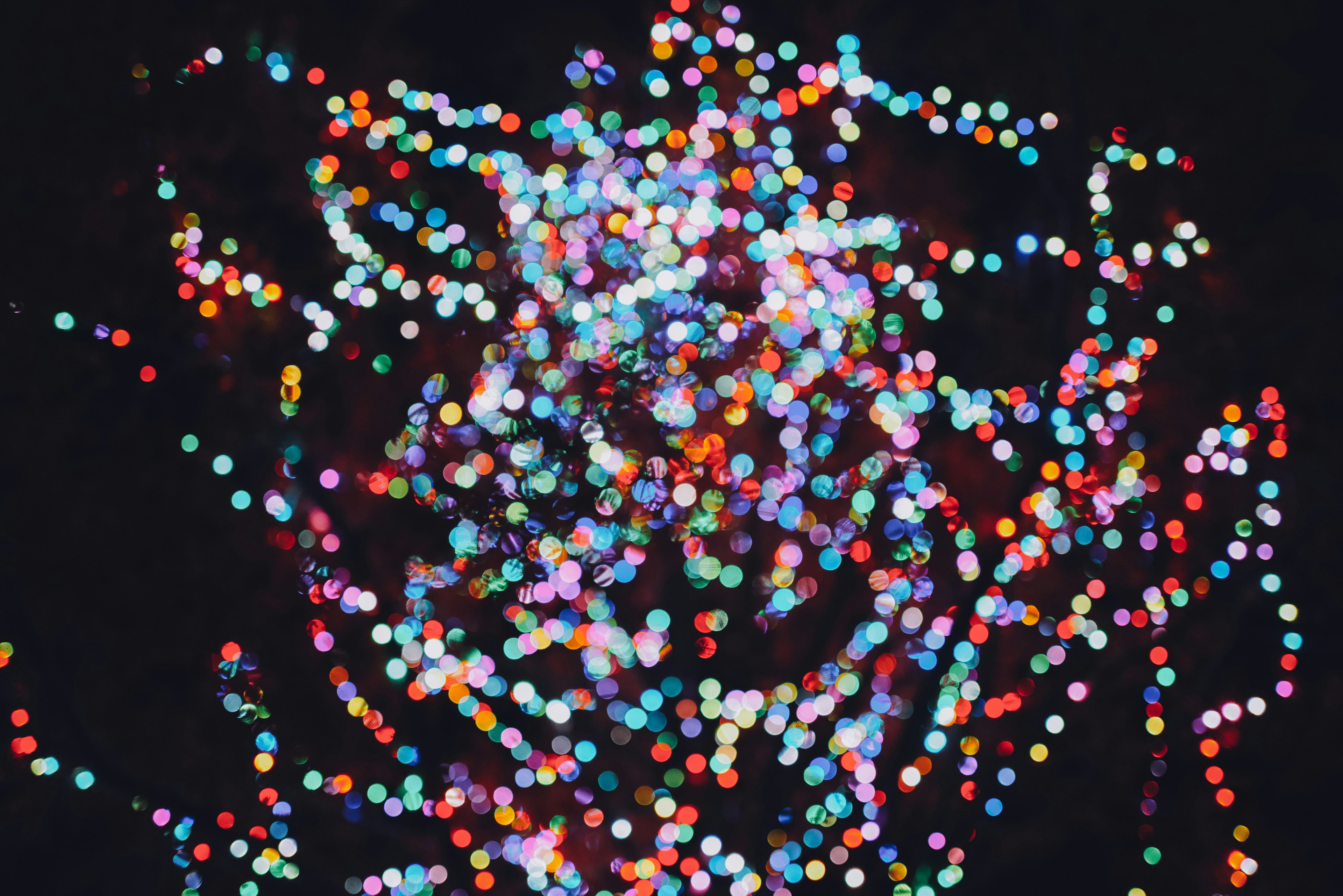 Abstract image of colorful light dots scattered against a black background