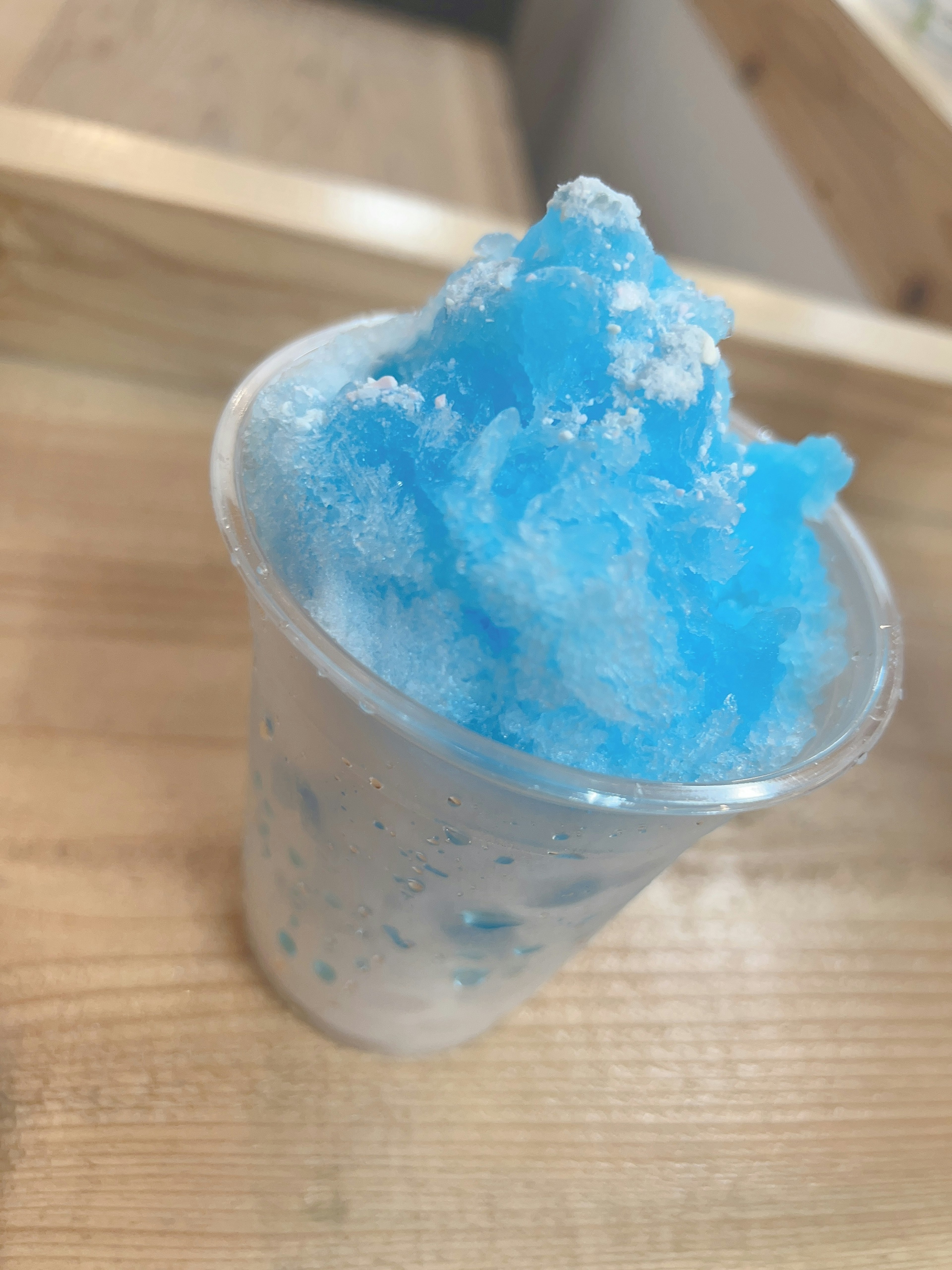 Blue shaved ice served in a clear cup