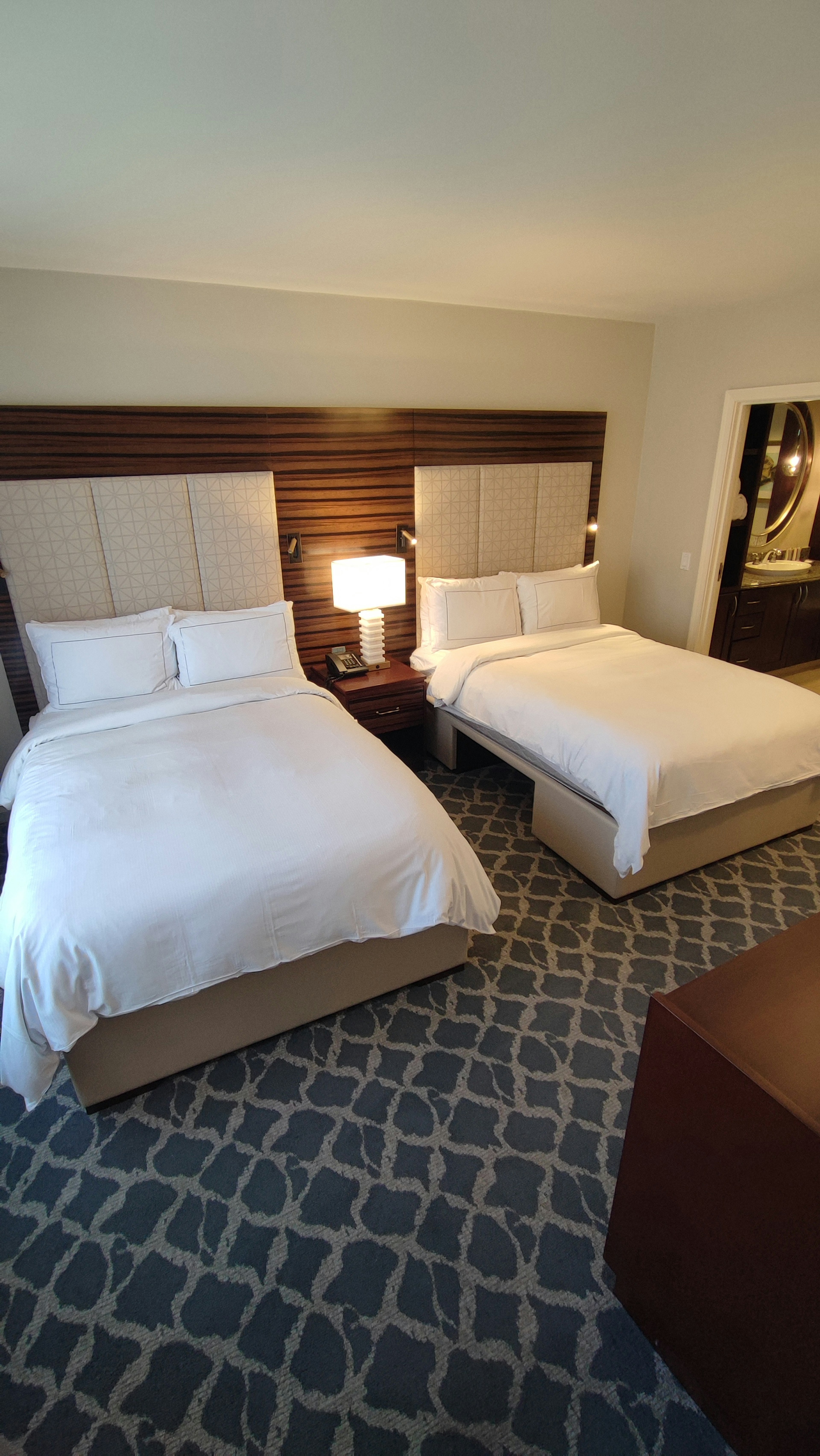 Bright and clean hotel room featuring two beds