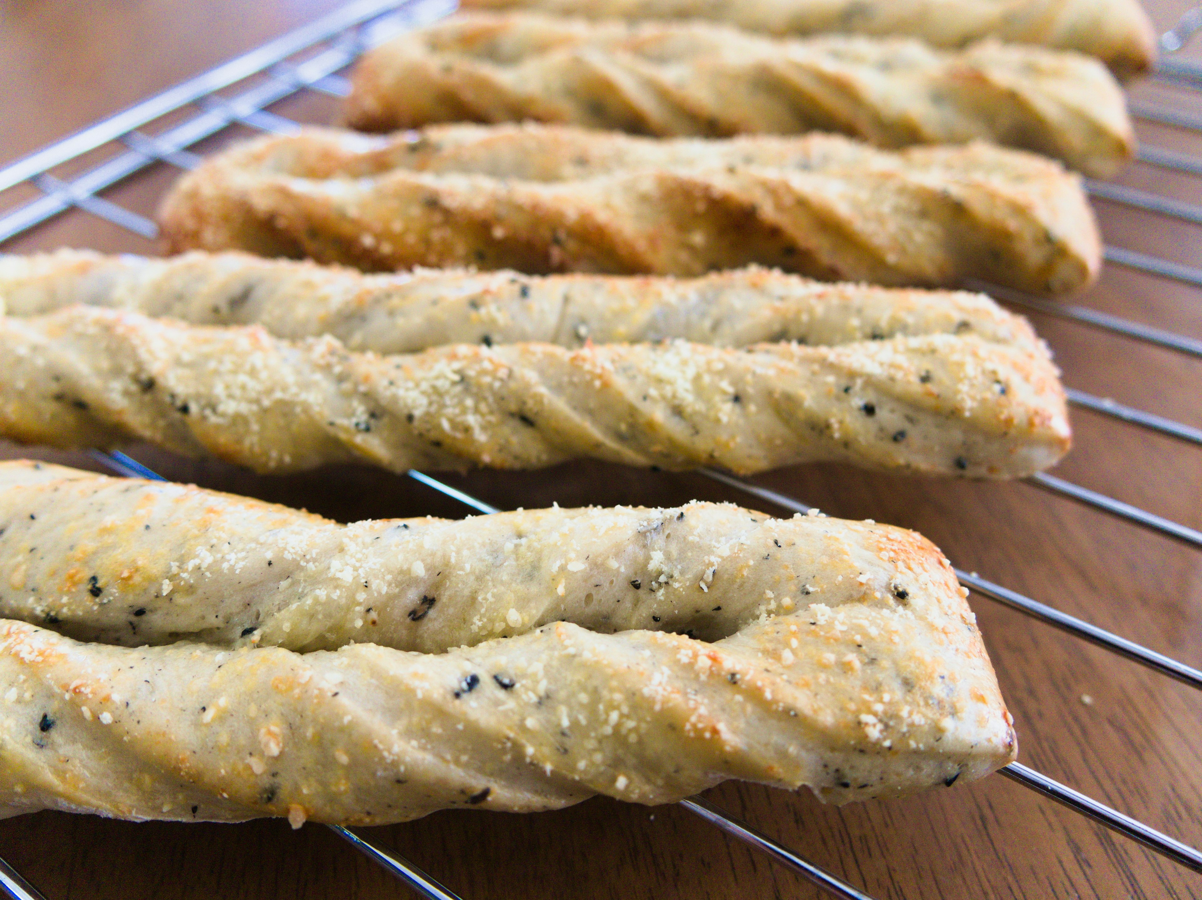 Freshly baked twisted snacks arranged on a cooling rack