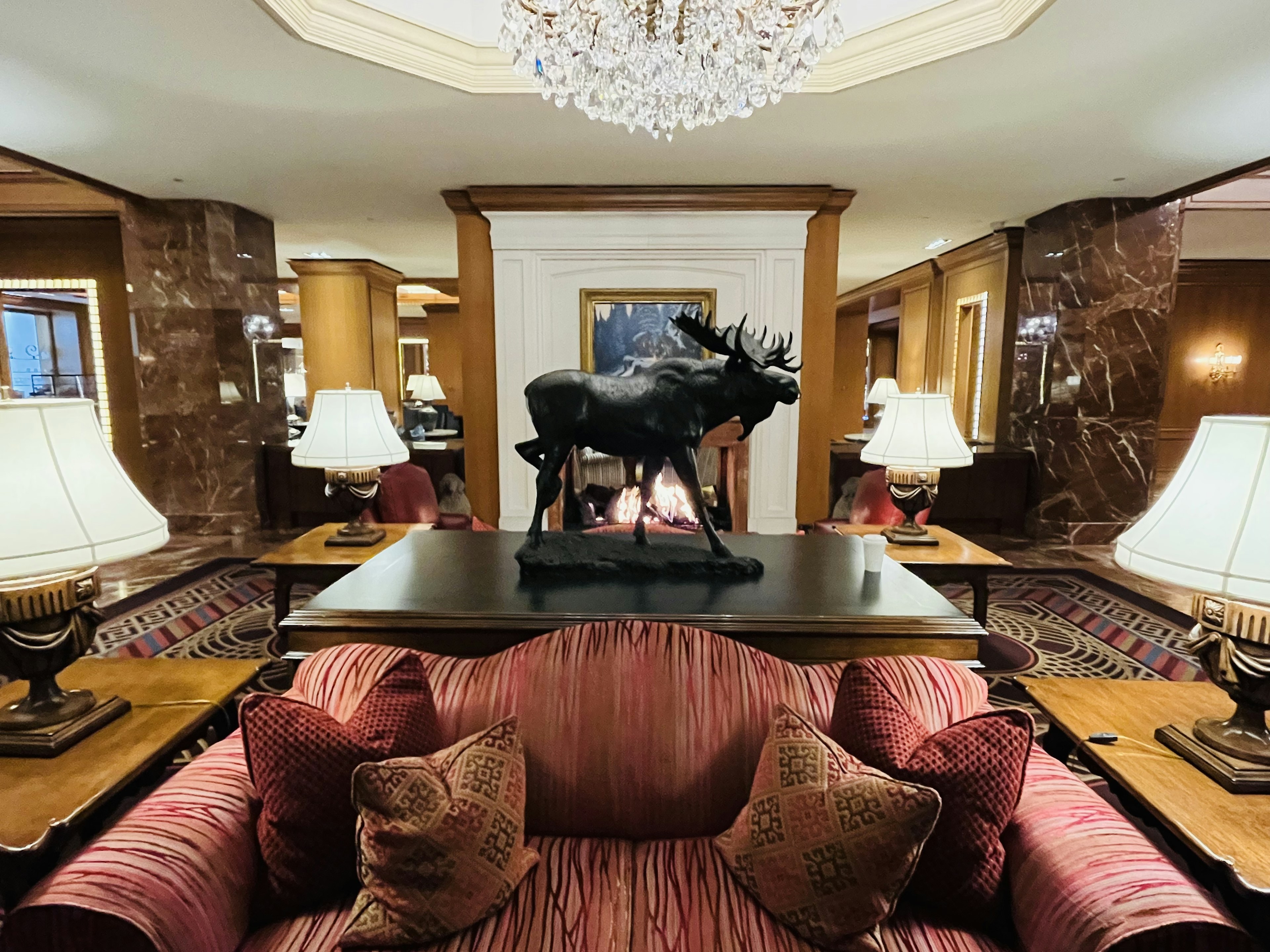 Luxurious lobby interior featuring a sofa chandelier and sculpture