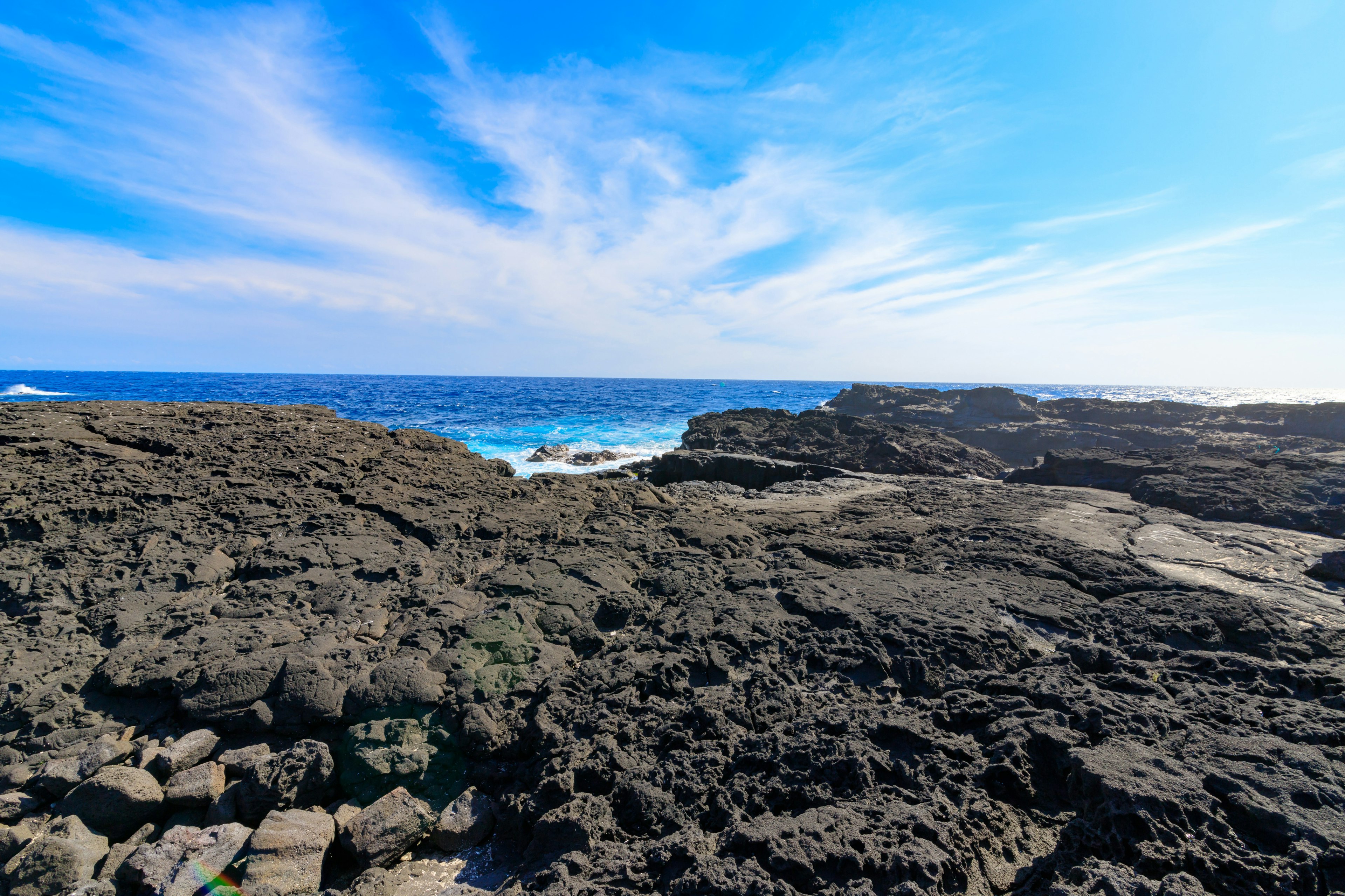 Rocky coastline with blue sky and ocean