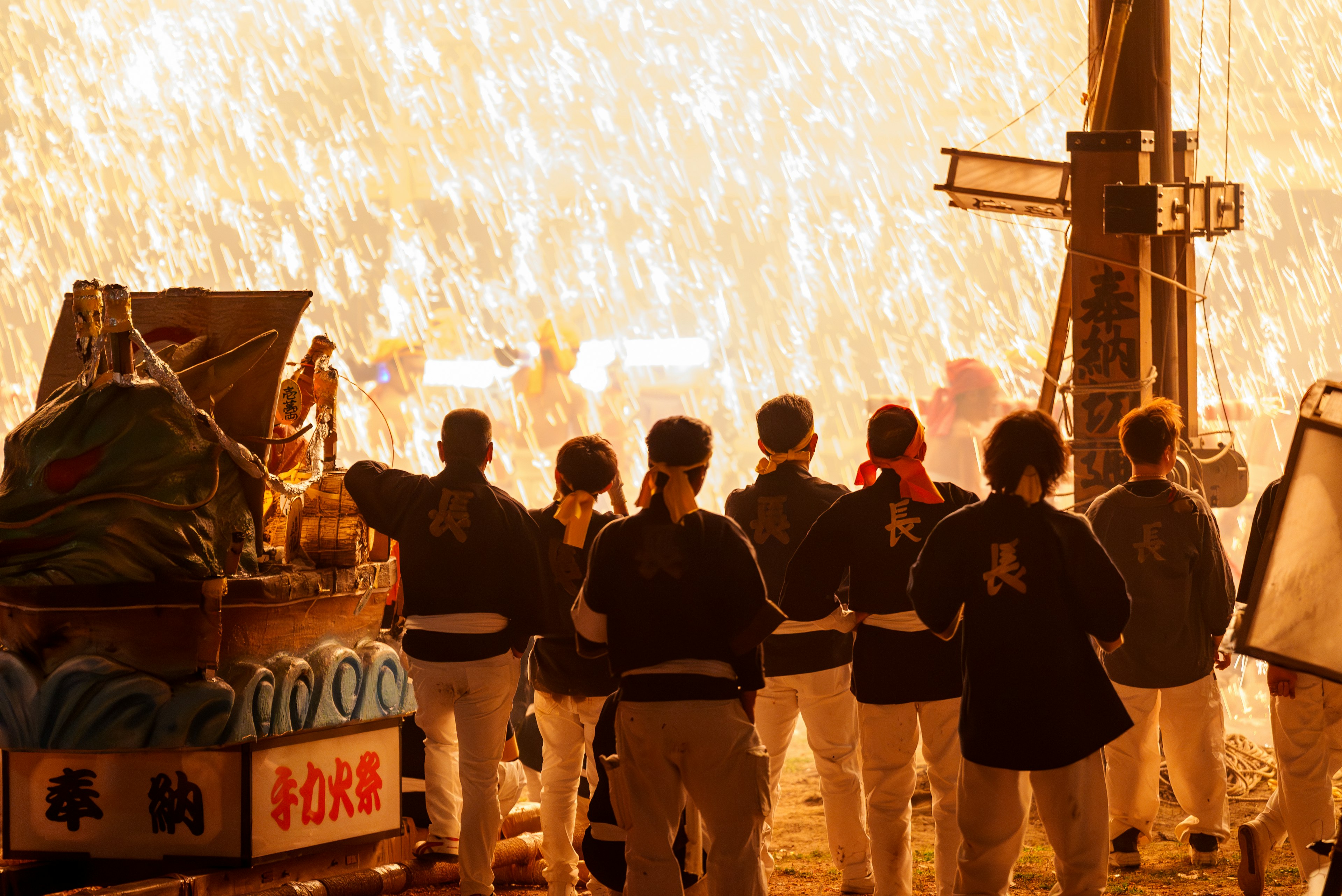 People preparing for a festival standing with their backs turned